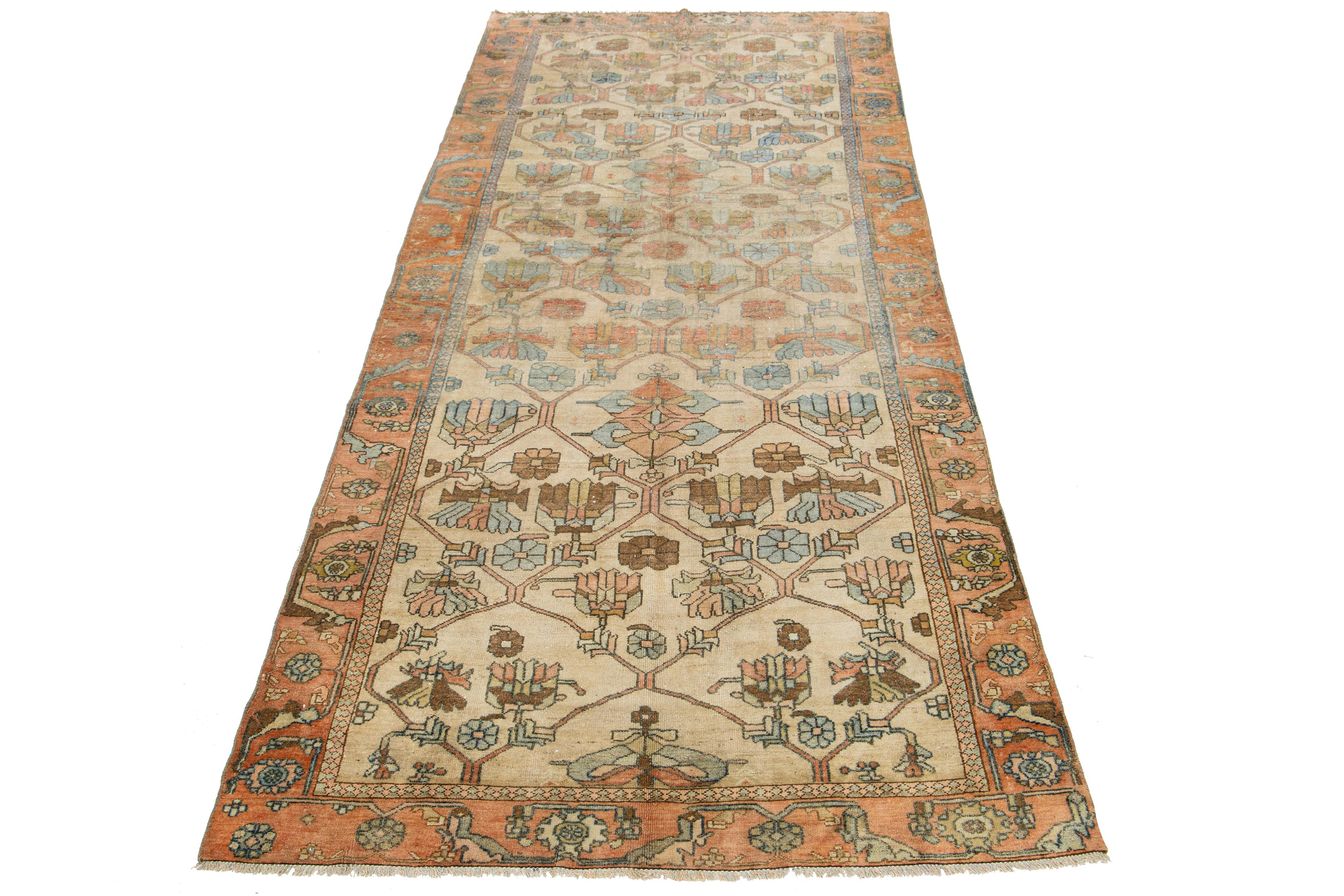 This antique Persian Malayer rug is hand-knotted wool. The design features a beautiful combination of beige and terracotta as the base, enhanced with blue highlights in a stunning, detailed floral pattern.

This rug measures 4'6