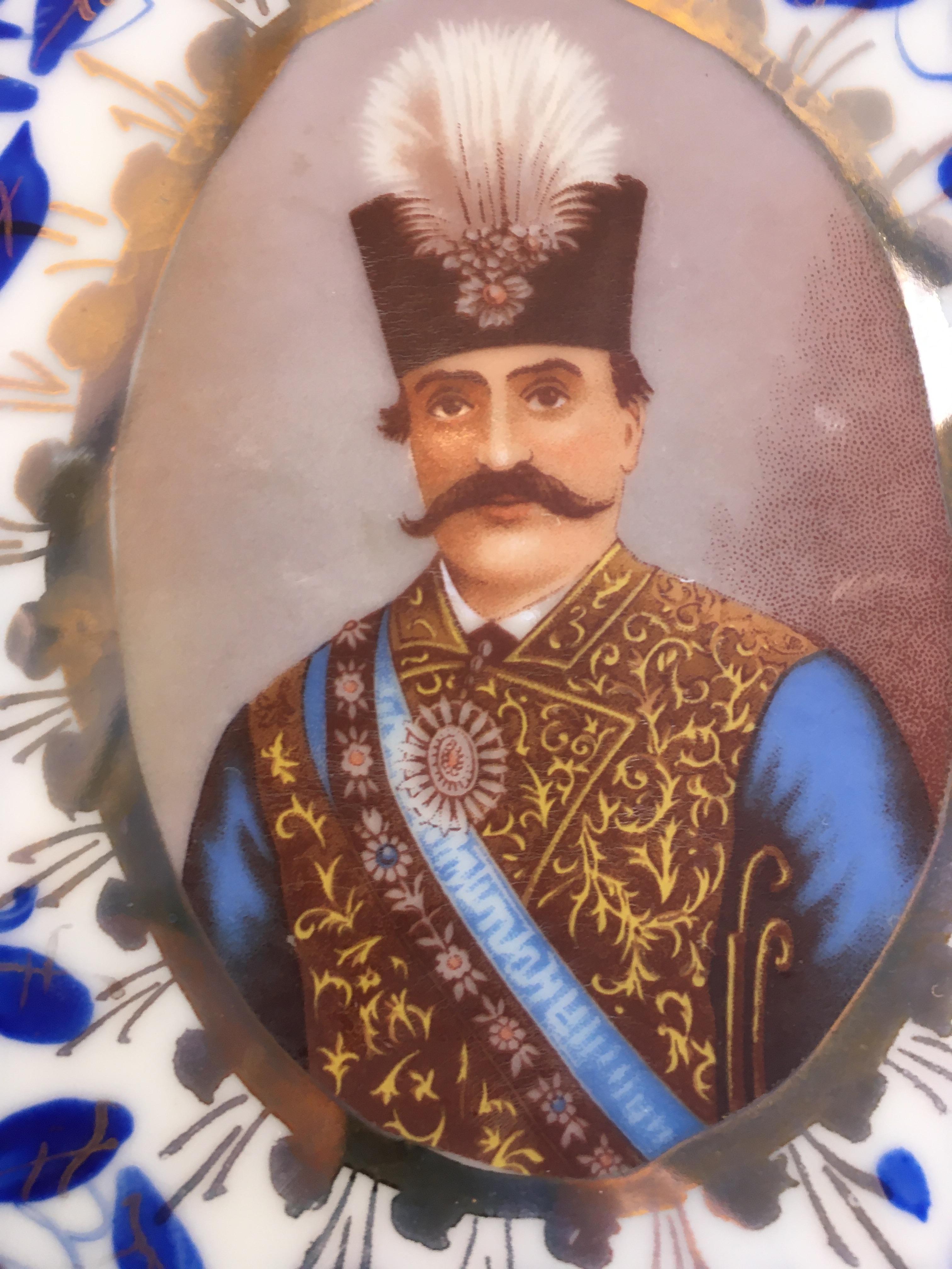 A large platter, bearing a single, central commemorative portrait of Naser al din Shah Qajar, the portrait facing slightly to the left (see companion platter facing slightly right, listed separately). The whole platter hand-painted in overglaze