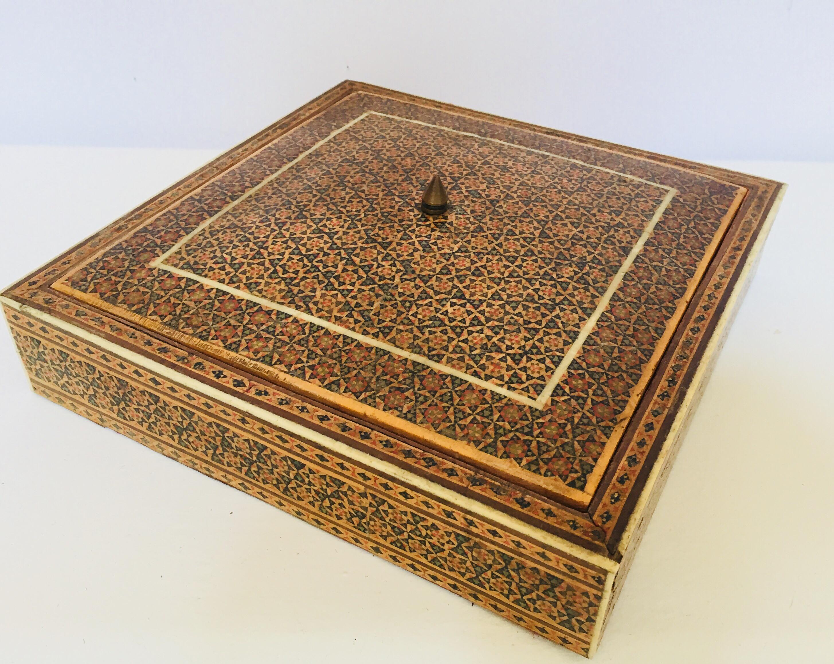 Persian micro mosaic inlaid jewelry box with lid.
Intricate inlaid middle Eastern Persian box with floral and geometric Islamic Moorish design in a rectangular form.
Moorish design bone inlay and marquetry, very fine artwork, lined in red