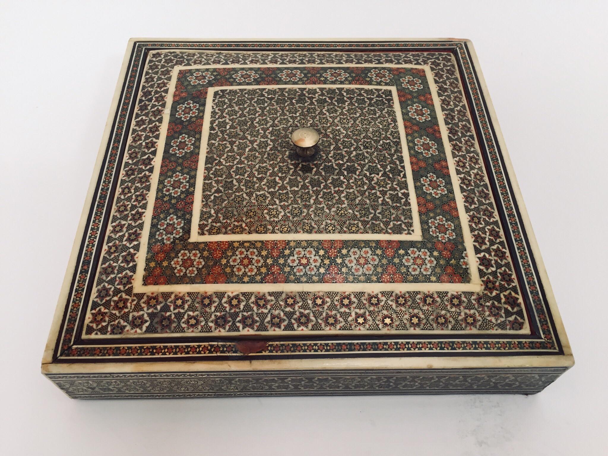 Persian Sadeli micro mosaic inlaid jewelry box with lid.
Intricate inlaid Middle Eastern Persian box with floral and geometric Islamic Moorish design in a rectangular form.
Moorish design bone inlay and marquetry, very fine Sadeli artwork, lined in