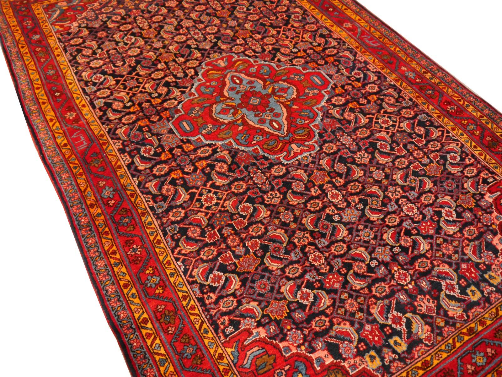 Semi antique Persian Bidjar rug of exquisite quality and color. This dramatic colored piece has its untouched original condition with high pile and original fringes and selvedge. Dark blue, light blue and dark red contrasts with sunset orange in the