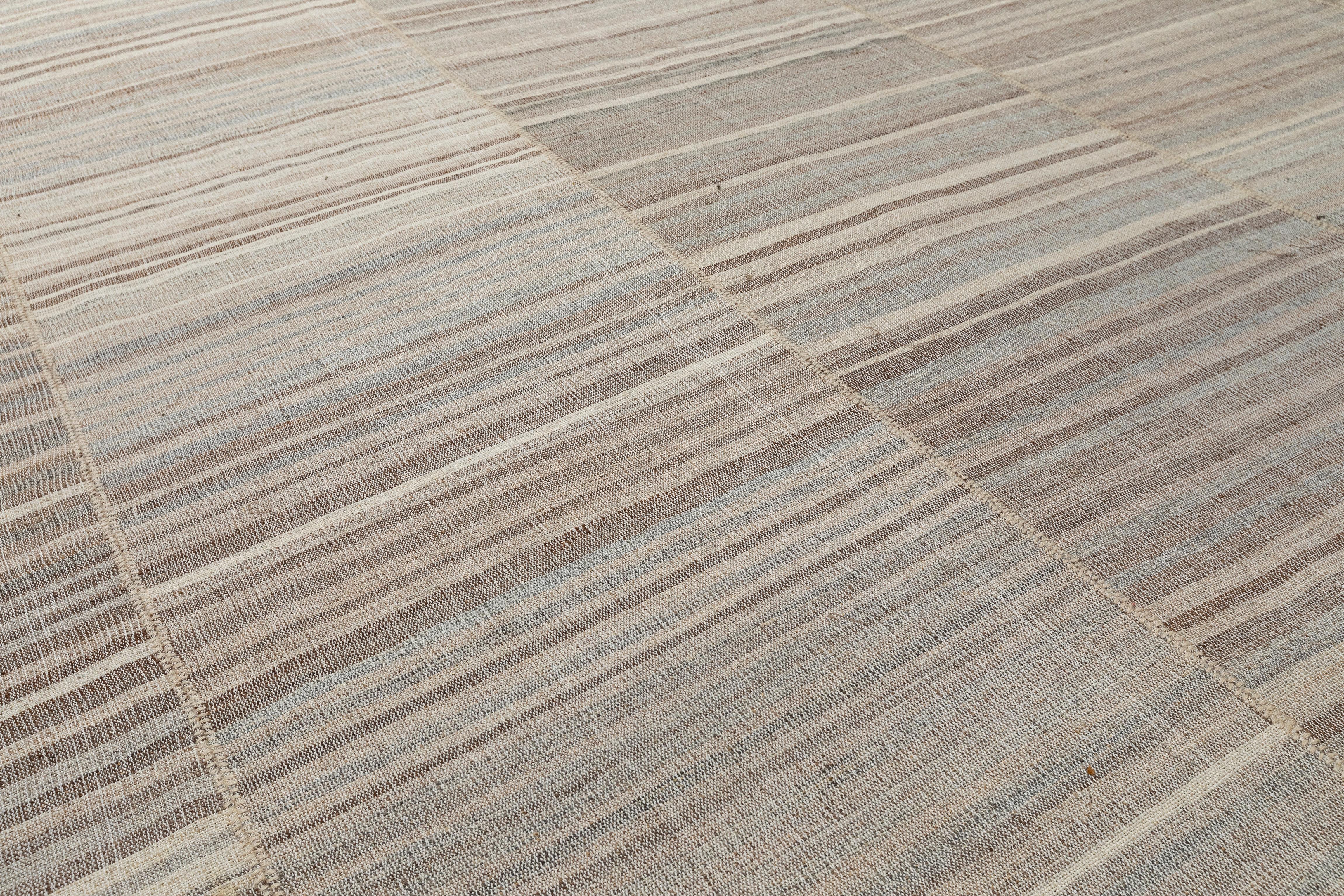 This handcrafted Persian flat weave rug features a serene neutral palette with elegant linear striping, offering a timeless and minimalist aesthetic. Woven from 100% hand-spun wool and dyed with natural vegetable pigments, each piece is made to
