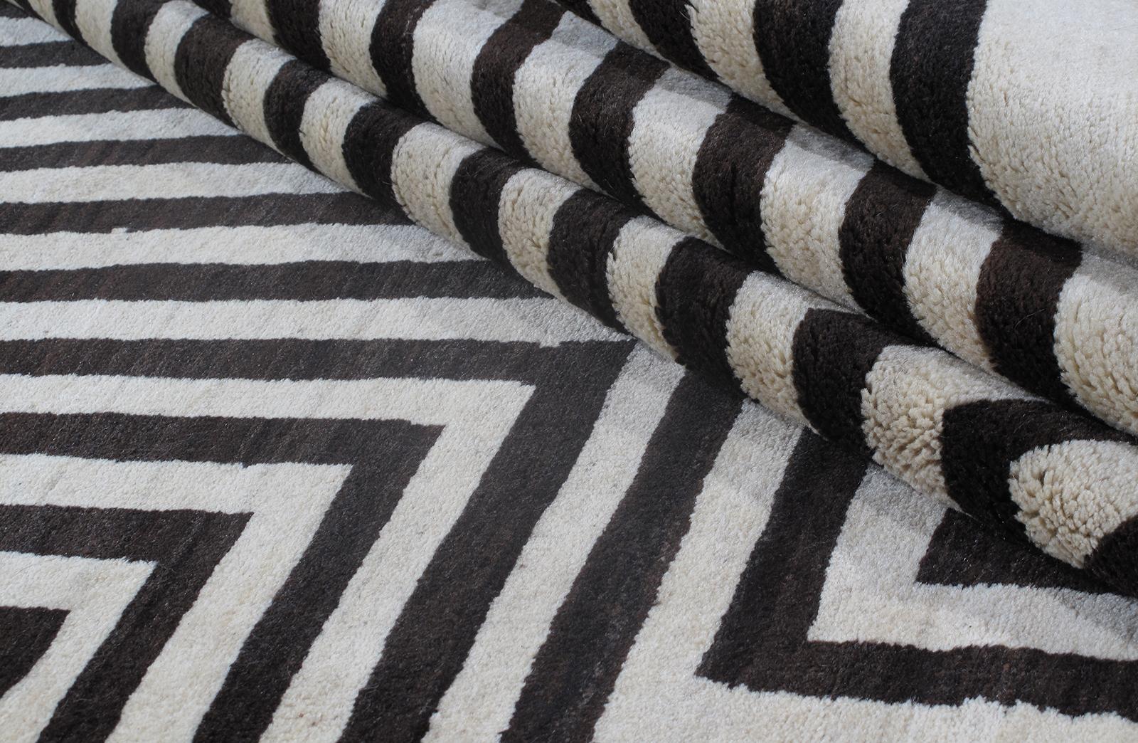 This Persian Shiraz bold graphic black and ivory pattern rug is hand-knotted, and made from the finest hand-spun, hand-carded naturally dyed wool. Many of the rugs made in the villages surrounding the city of Shiraz, in the province of Fars are