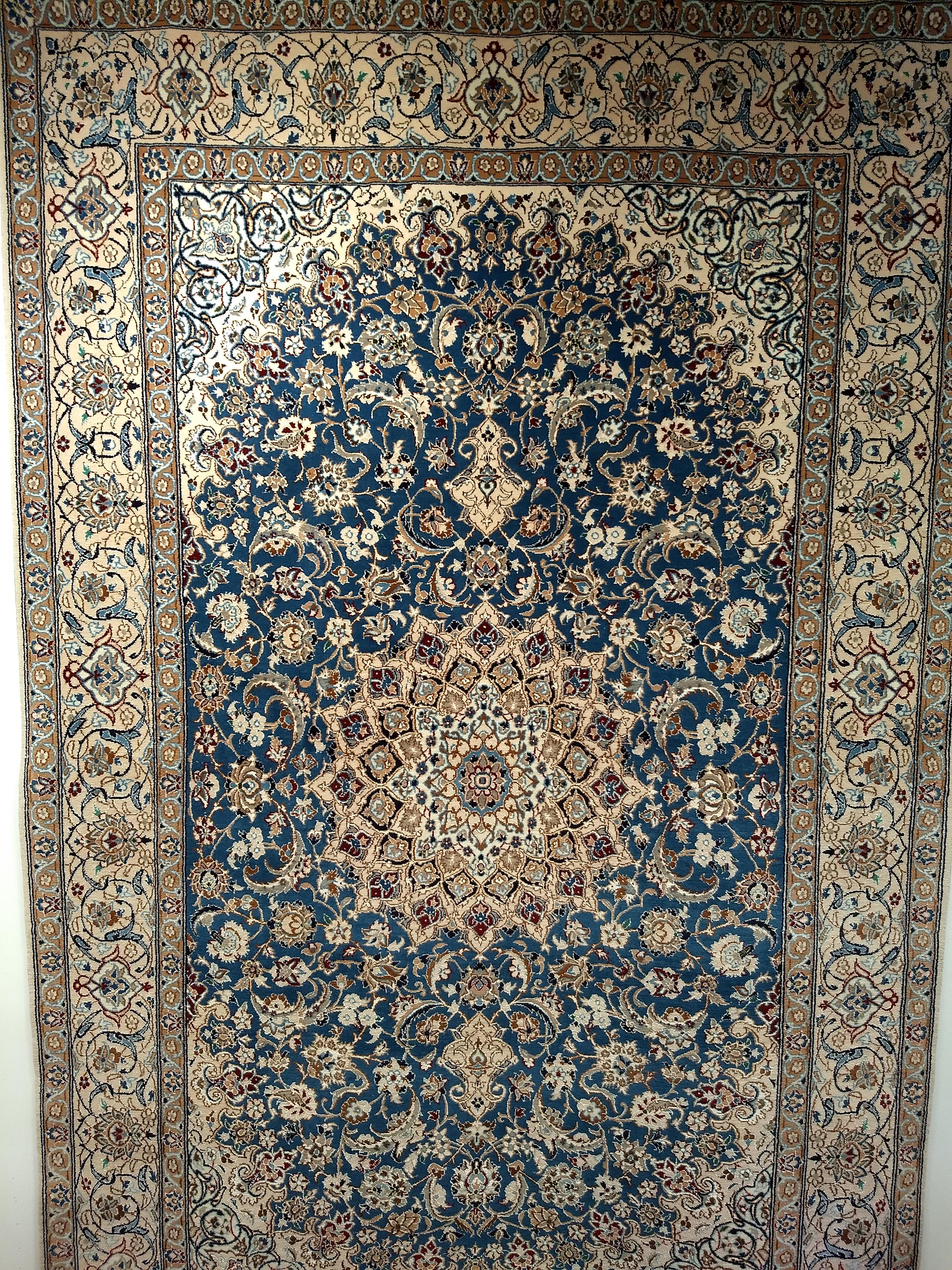 A beautiful Persian Nain room-size rug in a very rare French blue color and cream colors with silk highlights from the 3rd quarter of the 1900s.  The Nain rug has a beautiful central medallion set in a French blue field with designs in caramel,