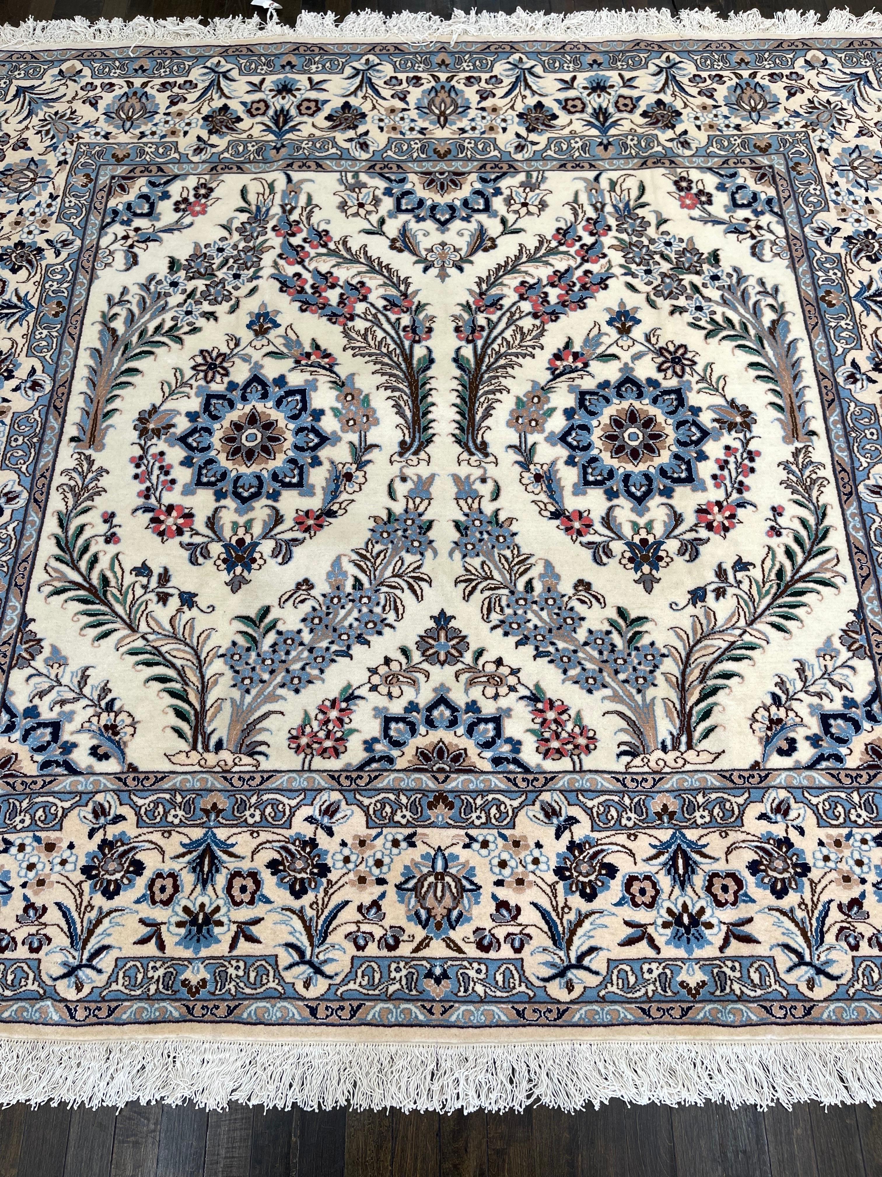 Finely woven Persian rug featuring floral, curvilinear designs on an ivory field framed by an ivory border decorated with flowers and bottehs. The impressive drawing of this carpet is a testimony of how fine classic persian rugs are made. The