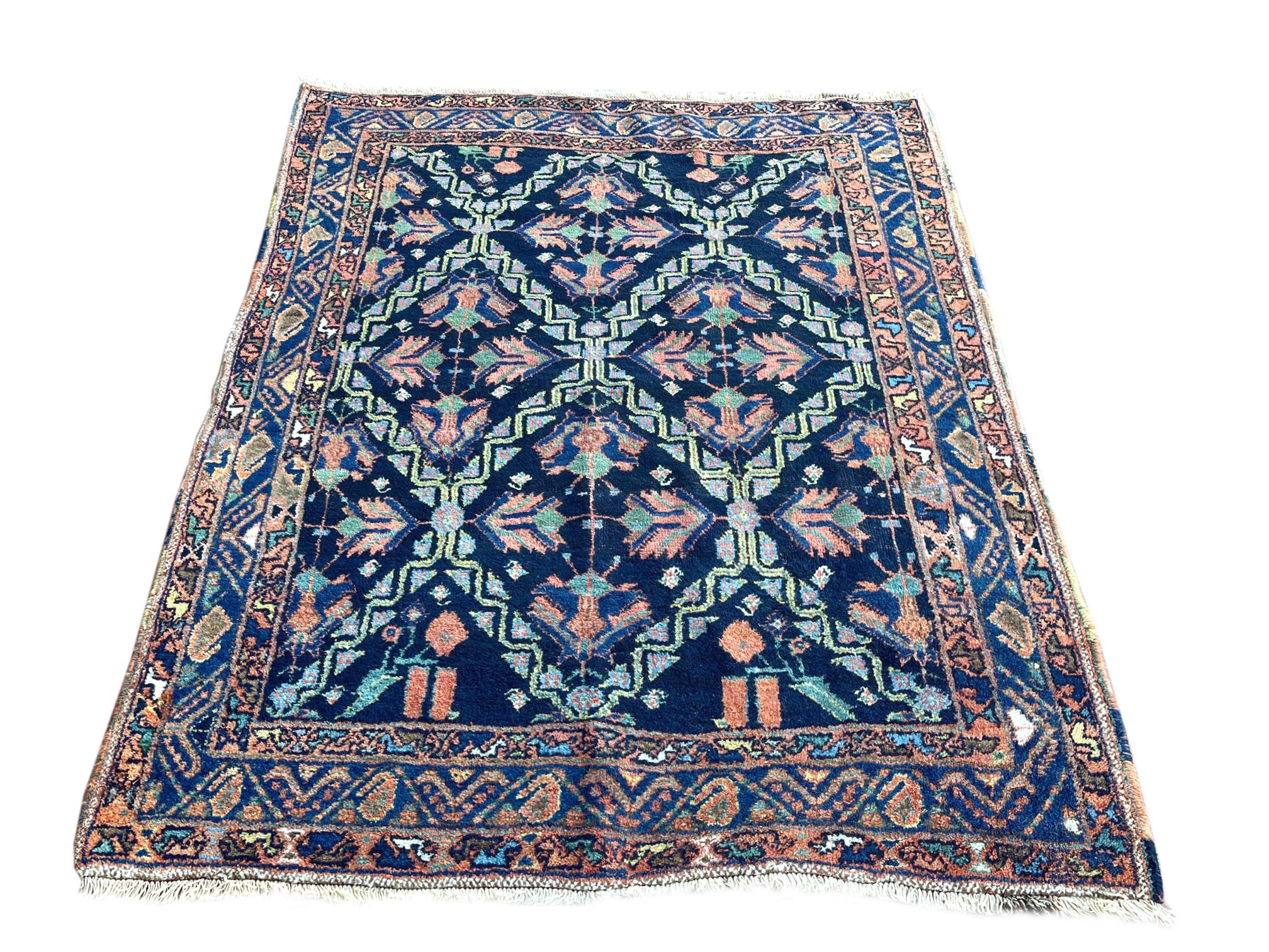 This stunning piece is from Northwest in Iran. Northwest refers to a diverse group of antique Persian rugs from west of Tehran, north of Bijar and south of Tabriz. The colors in this rug are dominated by different nuances of indigo blue, salmon,