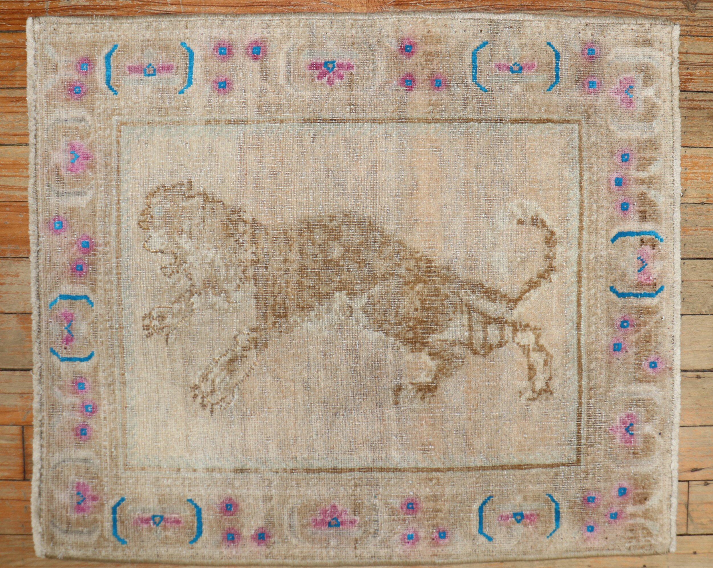 Mid-20th Century Persian Pictorial rug depicting a jaguar on a neutral field with colorful blue and pink accents on a narrow border.

Measures: 1'10'' x 2'3'' circa 1940.