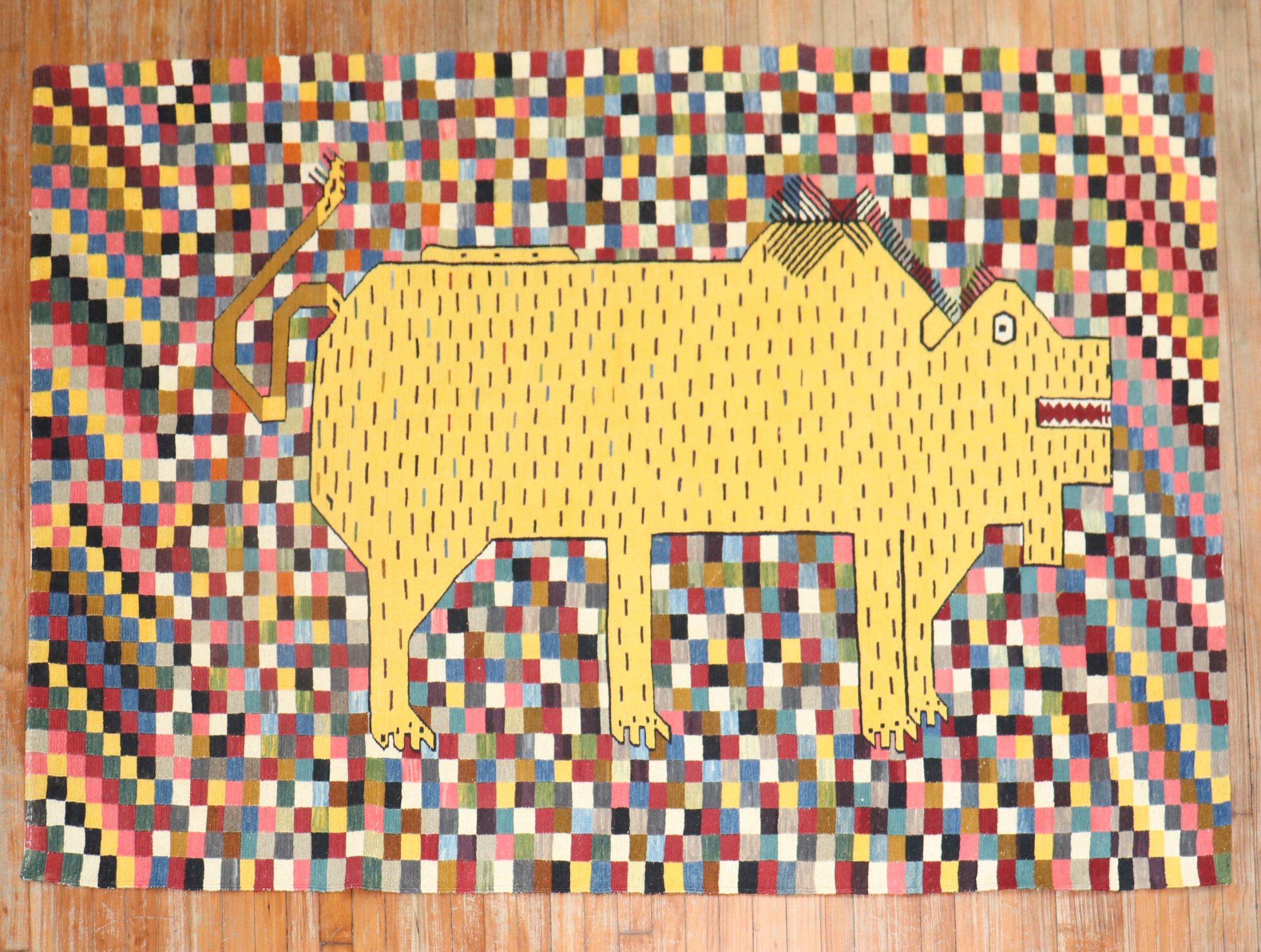 Late 20th Century Persian Kilim with a yellow rhinoceros on a colorful checkered field.

Measures: 4'11'' x 6'11''.