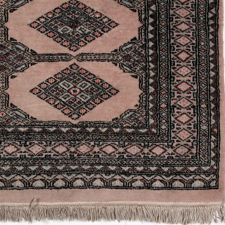 Warm tone, vintage Persian rug with diamond shaped design.
