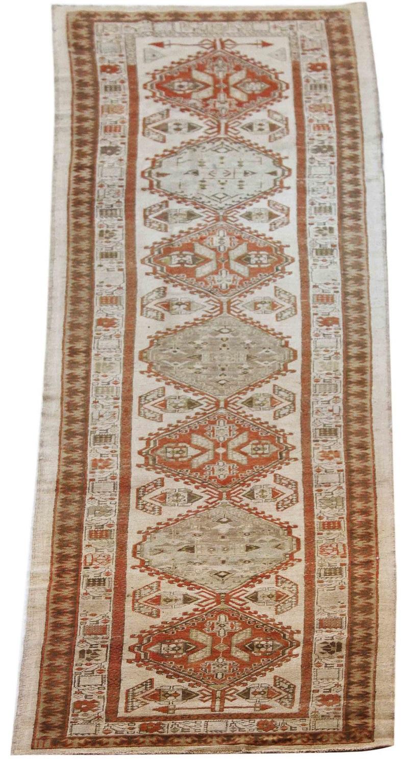 Discover the elegance of Persian Sarab featuring Runner Rug in Circa 1910. Designed with Wool and GrayIvoryRed, this exclusive design is perfect for enhancing your space.