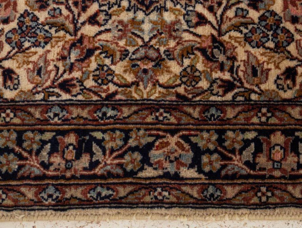Persian Sarouk carpet with hand-woven repeating floral design encircling a central rosette medallion. 

Dealer: S138XX