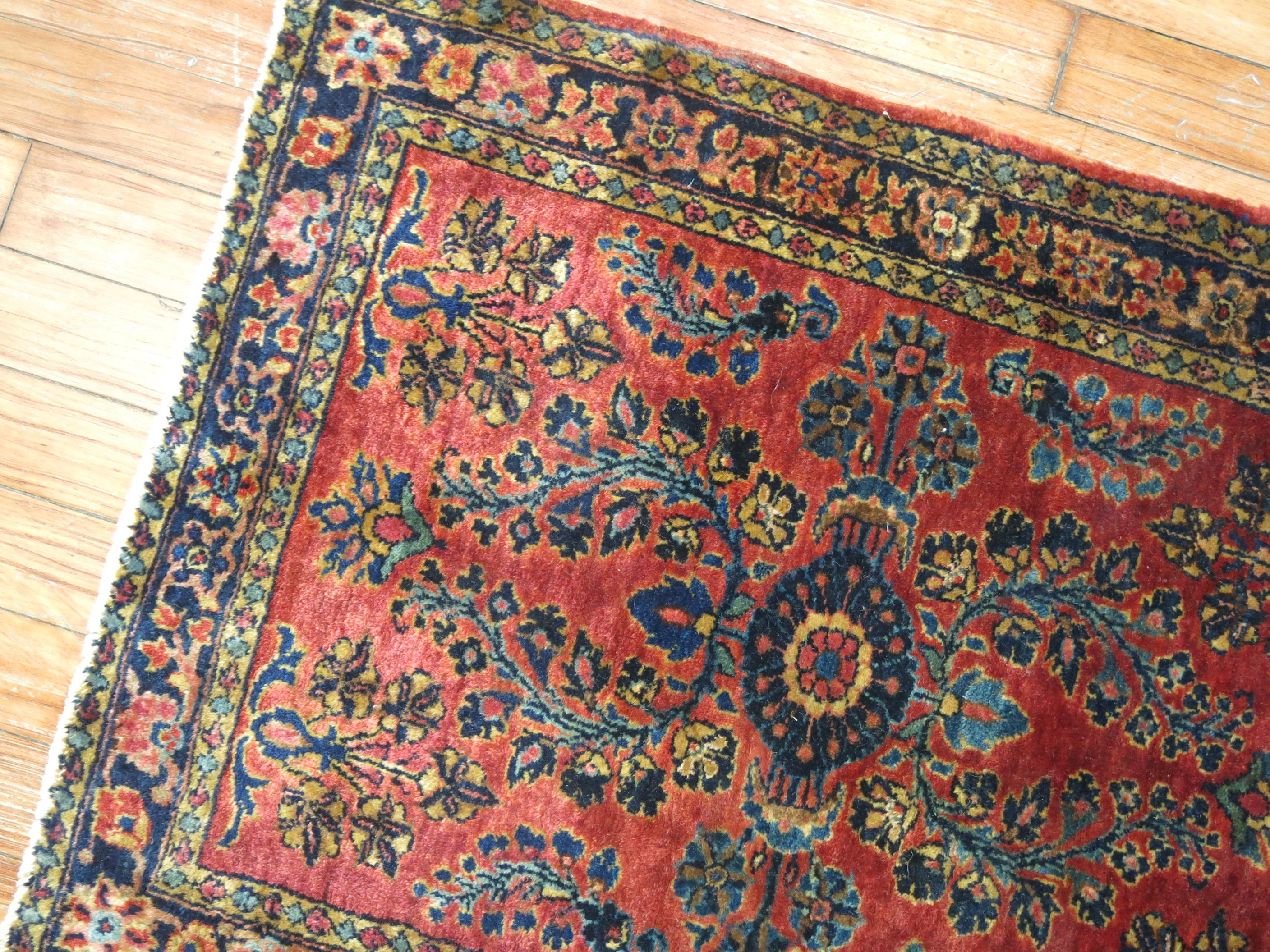 Early 20th century Persian Sarouk mat.

1'10'' x 2'5''

Before the 1920s the Sarouk design was the most popular of Persian rugs worldwide. Most of them consist of deep red fields with navy borders. Rarely are they found in inverse colors like this