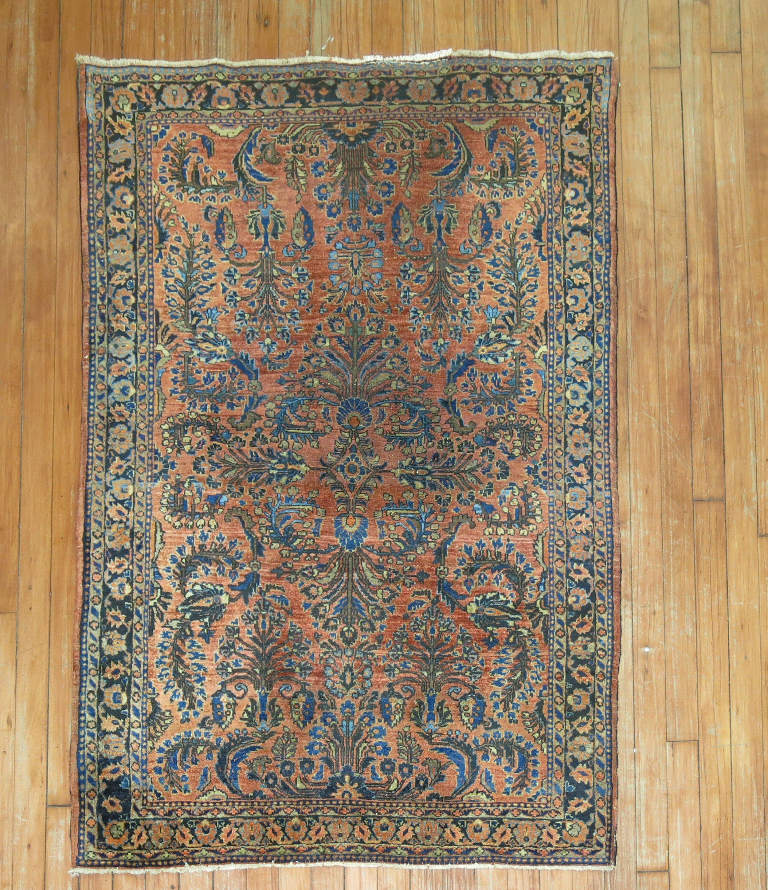 An early 20th century classic Persian Sarouk rug in copper, blue and brown .

Measures: 3'3'' x 4'9”.

