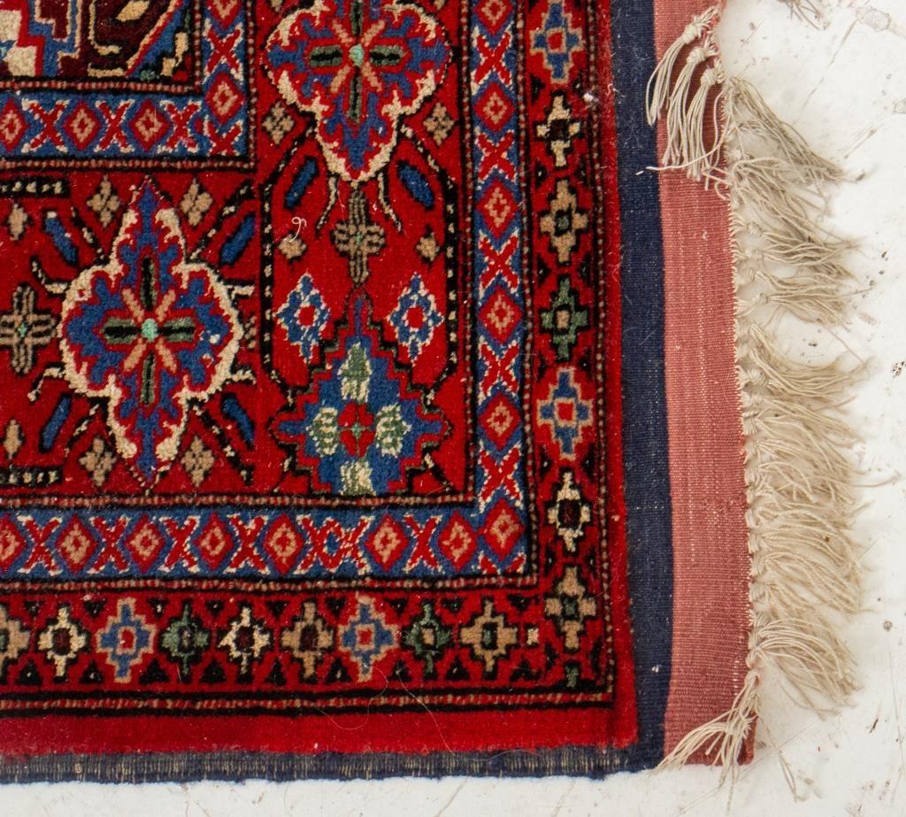 Persian hand-woven shiraz carpet with repeating geometric medallion design on a red ground. 

Dealer: S138XX