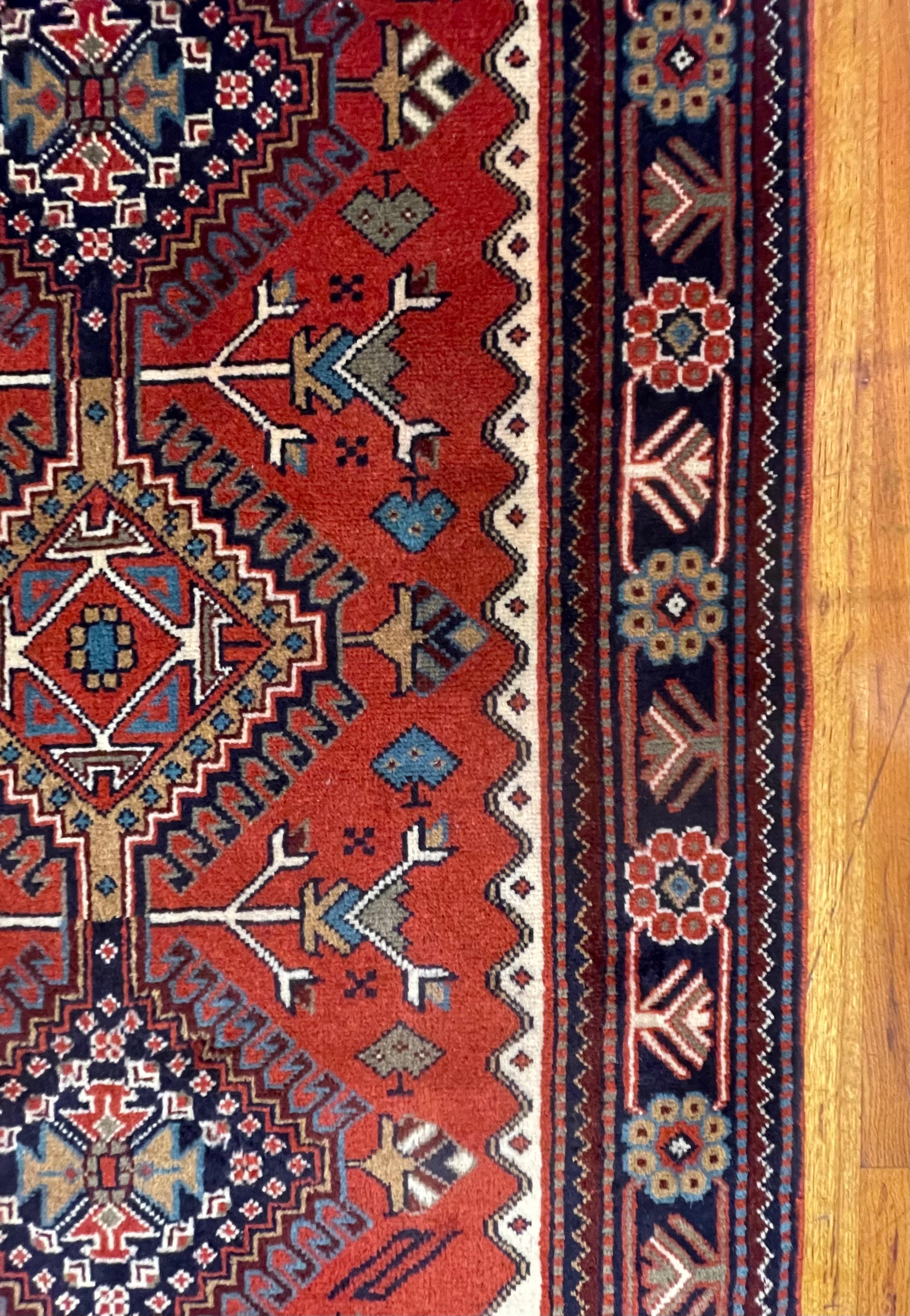 This rug is an authentic piece originating from Shiraz, Iran, a region celebrated for its rich tradition of hand woven rugs. Crafted entirely from wool, both the pile and foundation showcase the durability and natural appeal of this timeless