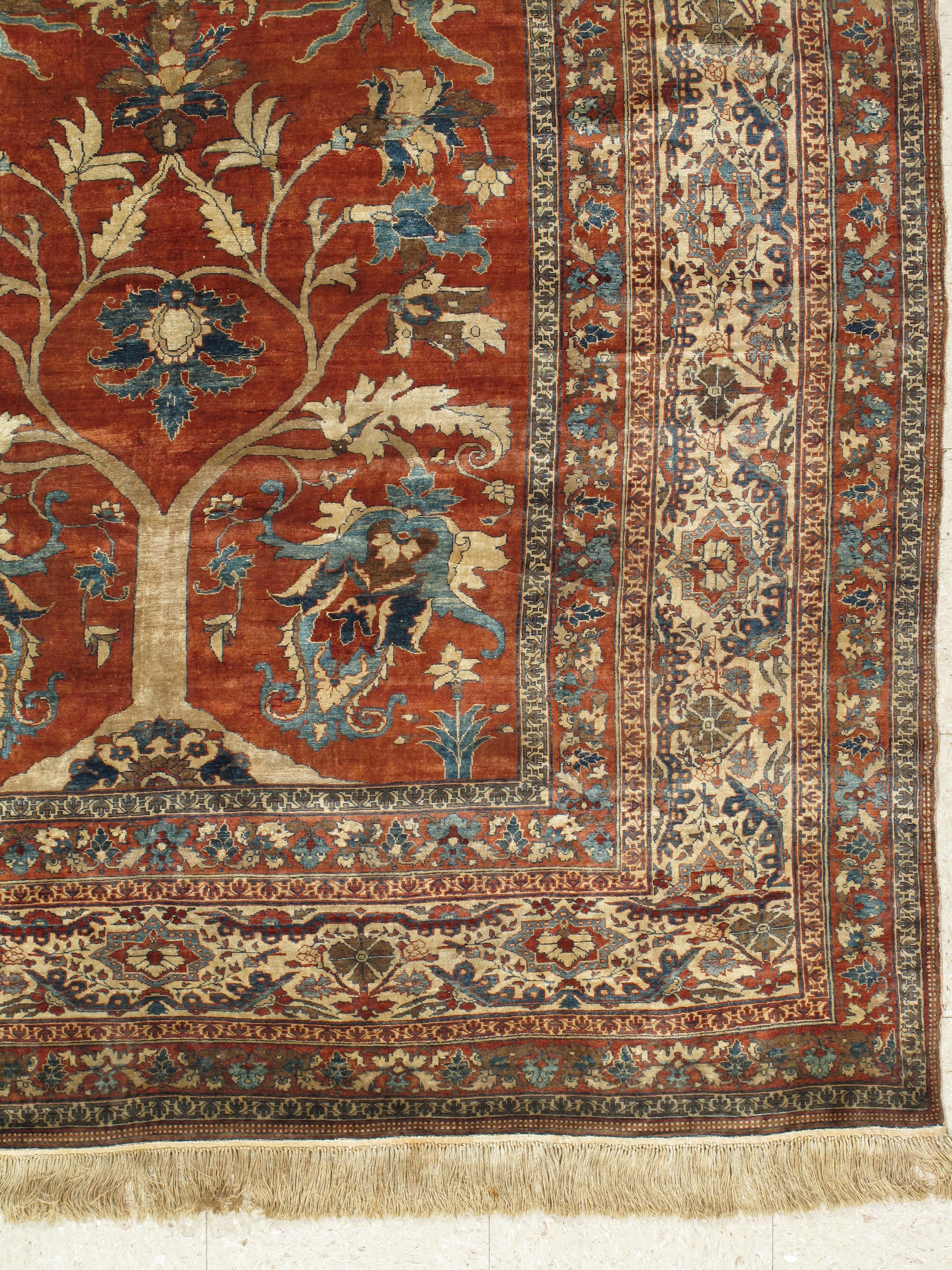 Antique Heriz wool carpets are renowned for their crisp, abstract geometric interpretation of classical Persian rug design. Heriz carpets woven in silk, however, are quite distinct and tend to preserve the fluid, sinuous arabesque detail of