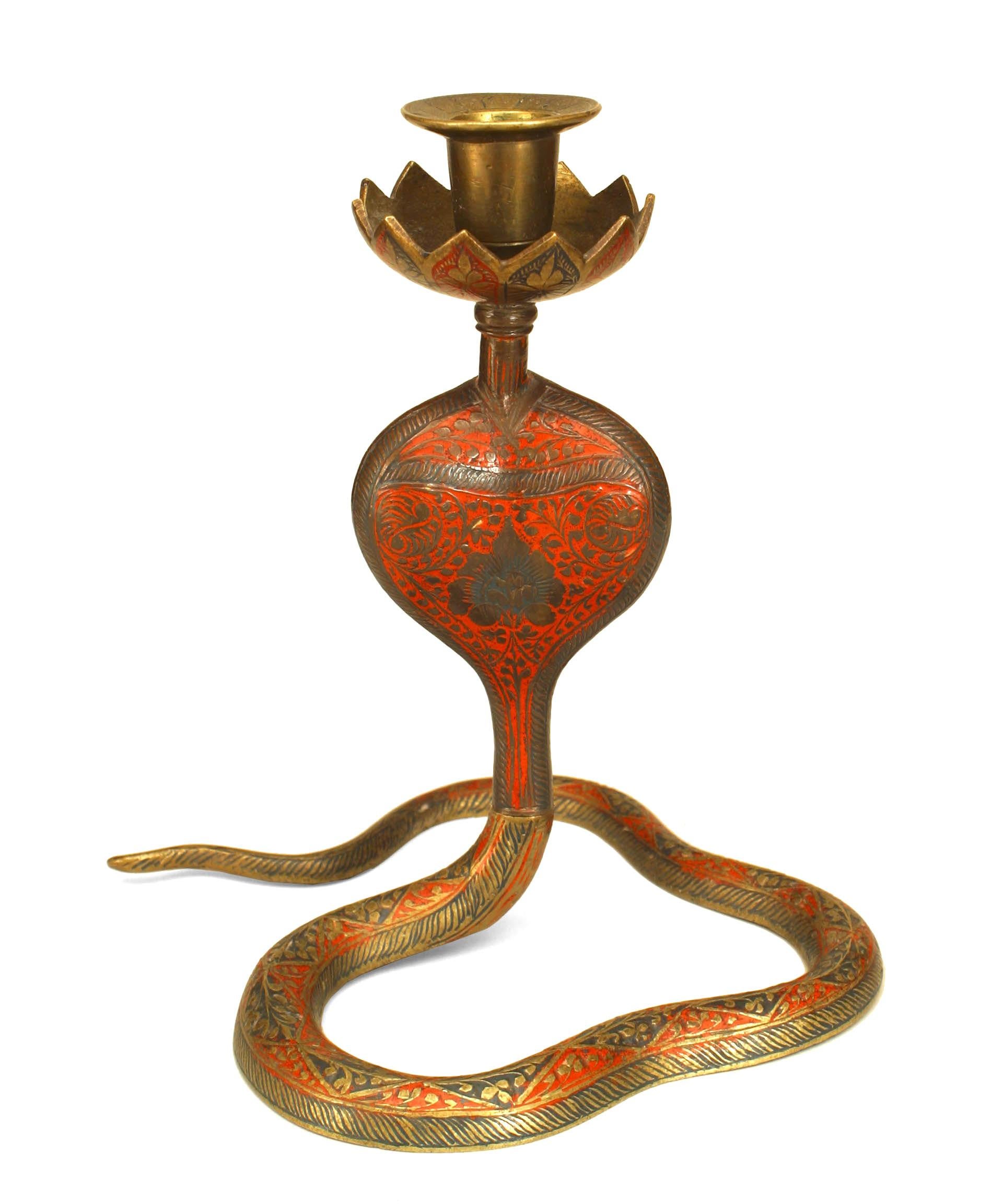 Middle Eastern Persian-style brass candlestick in the form of a cobra snake with incised black and red enamel decoration.

Condition: Good; Wear consistent with age and use