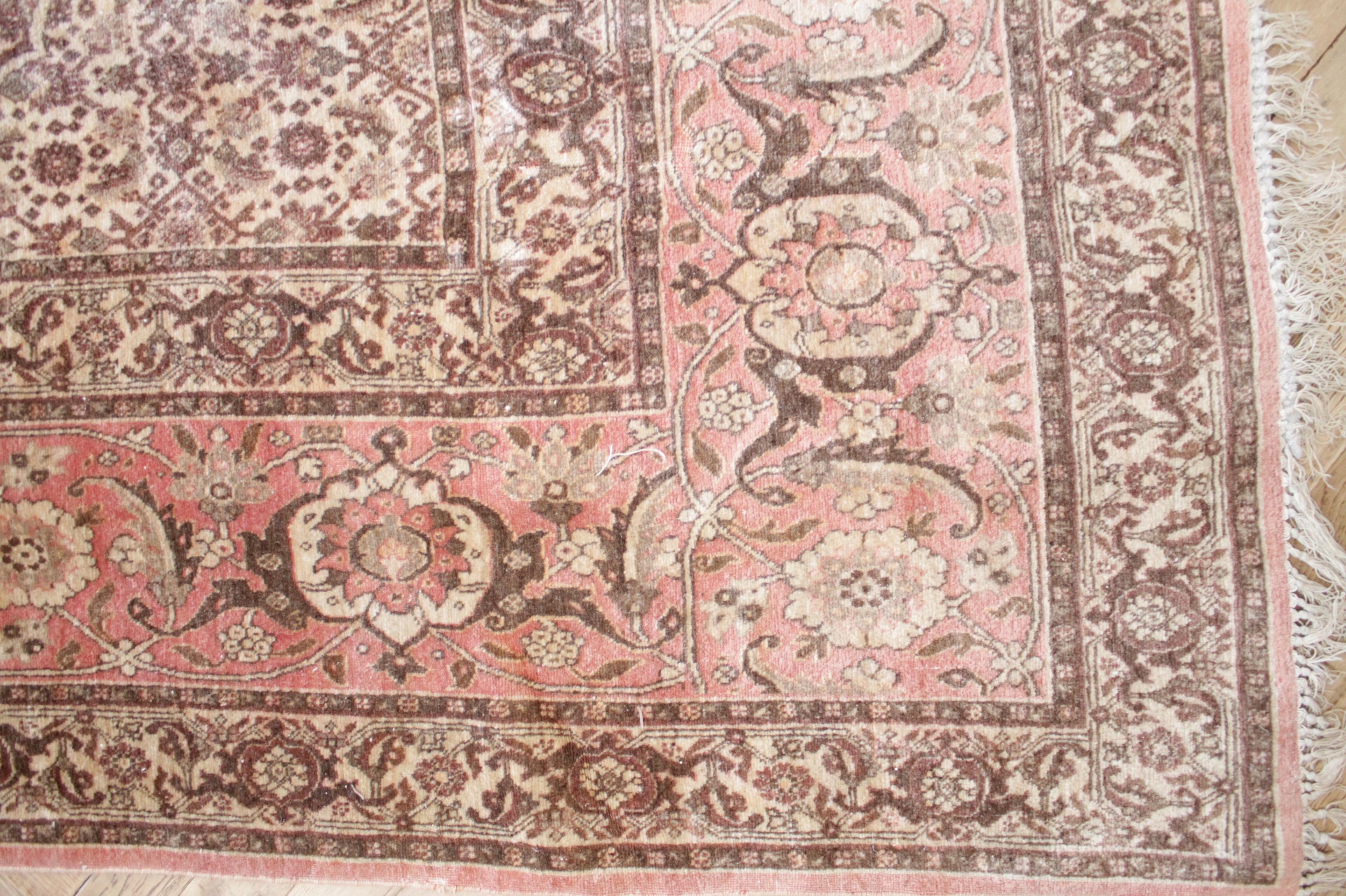 Lovely vintage rug, colors are faded pinks, creams, browns, with tassel ends. Tassels are worn and some longer than others. Subtle markings shown in the photos, area of the rug where there are minor discolorations. Its a beautiful rug, in good