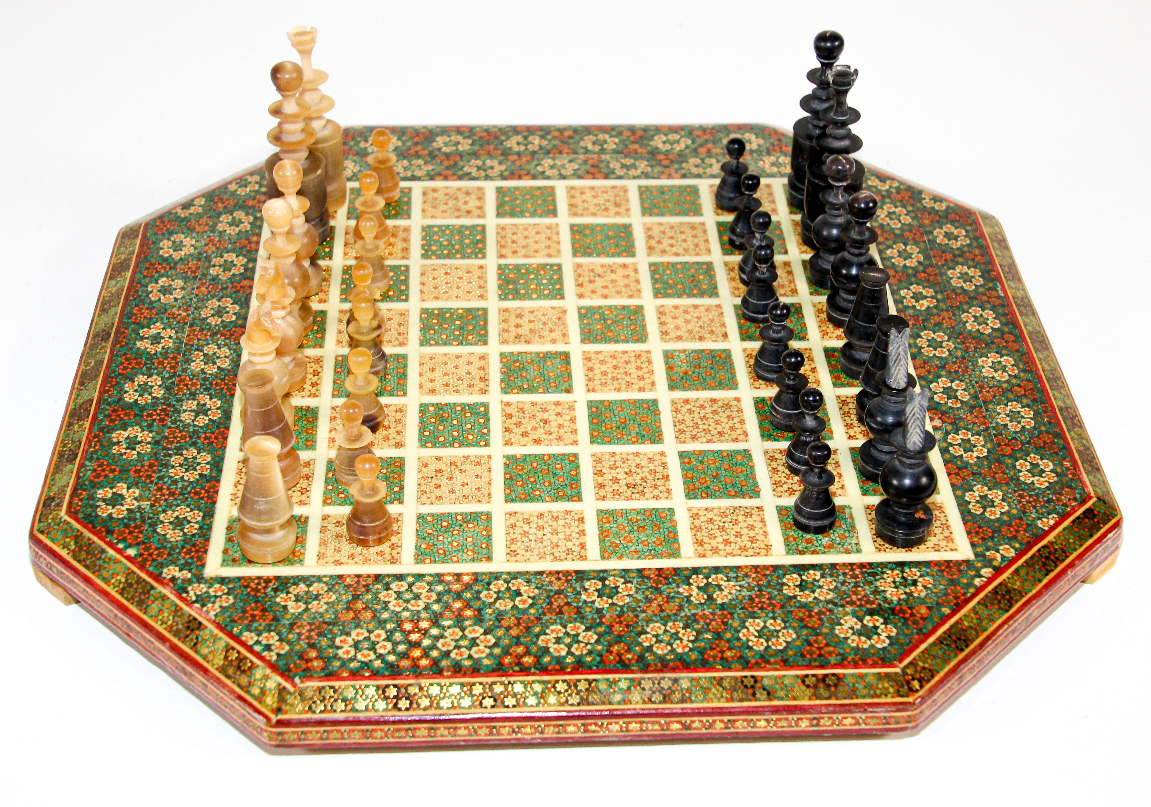 Intricately inlaid handcrafted Persian styled chess game board and handcrafted horn and pone chess pieces.
Handcrafted beautiful Middle Eastern Moorish style Khatam chess board covered with very delicate micro mosaic marquetry from the ancient