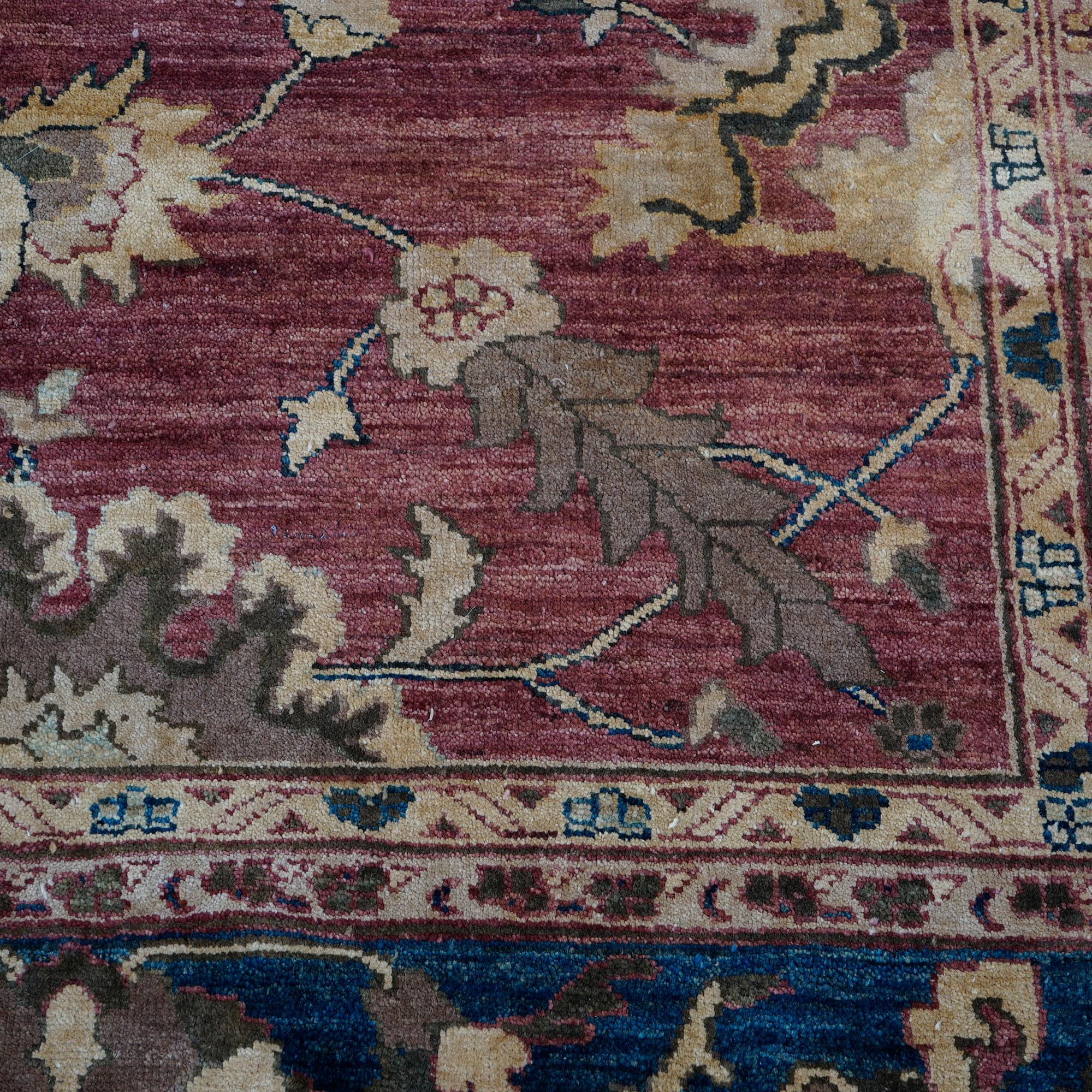 A Persian Sultanabad oriental rug offers wool construction with floral and foliate elements on red ground, 20th century.

Measures- 145''L x 121''W x .5''D.