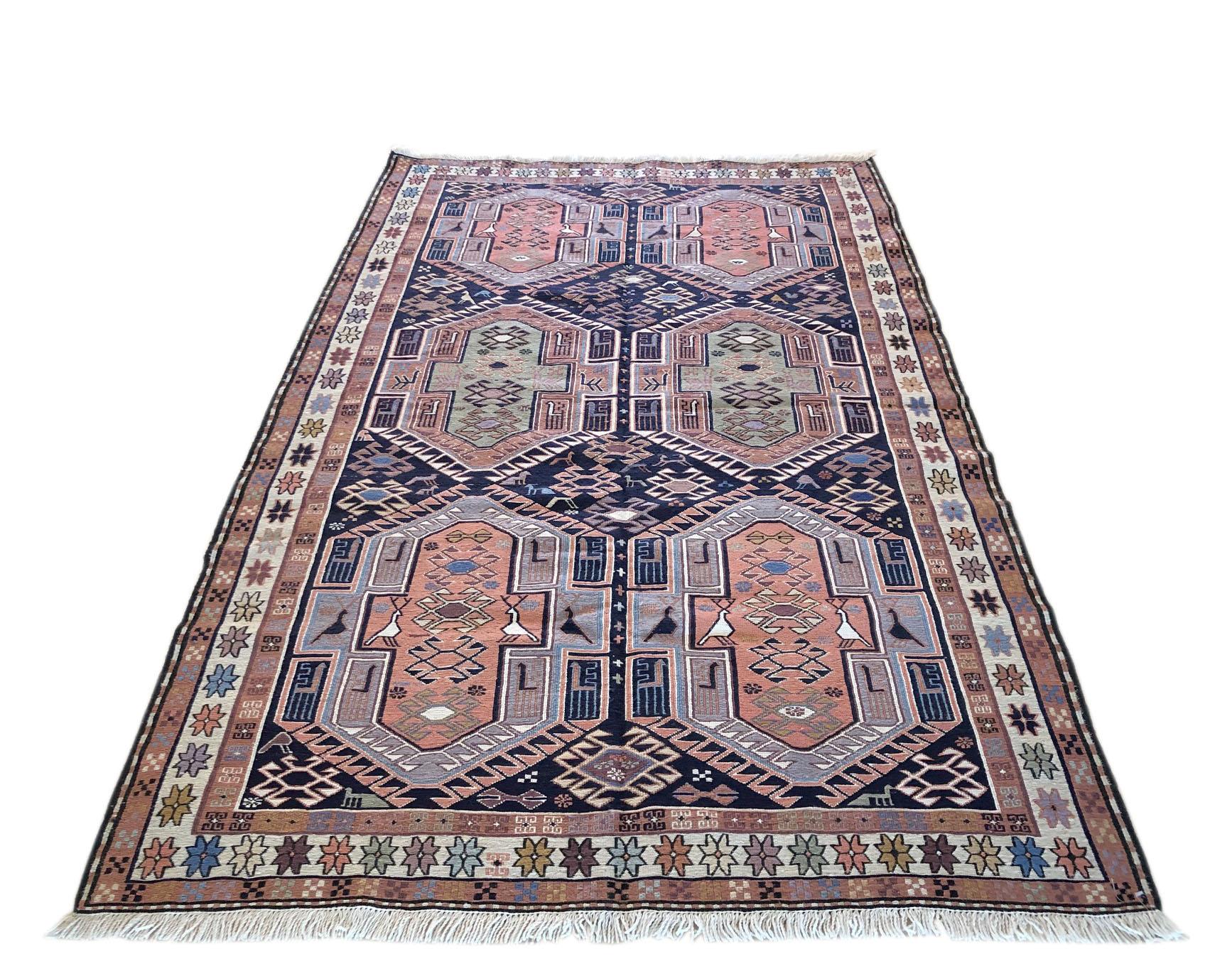 This rug is a Sumak rug which is a type of brocading or flat-woven pile. This is a flat-weave, rug that is thicker than the Kilim and very sturdy however they are not reversible like Kilims due to the non-clipped yarns are left on the back. The pile