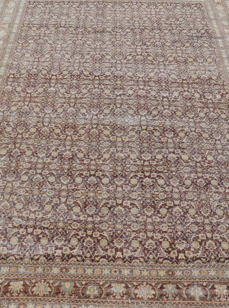Measures: 6'4 x 9'10 
Persian Tabriz Antique Rug in Herati Design In Dark Arginine, Blue, and Tan. Keivan Woven Arts / rug EN-14794, country of origin / type: Iran / Tabriz, circa 1920.

This beautiful early 20th century Persian Tabriz rug has been