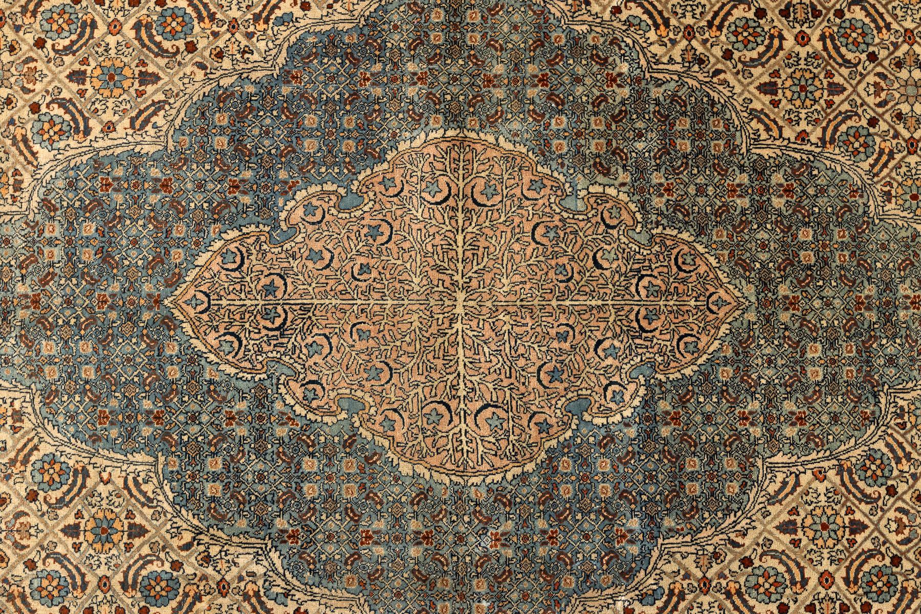 Tabriz – Northwest Persia
This is a fine Tabriz with a design inspired by the art of the Persian master Hadji Jallili. Except for the diminutive orange medallion in the centre, the entire rug is covered with a herati design—a repeating geometric