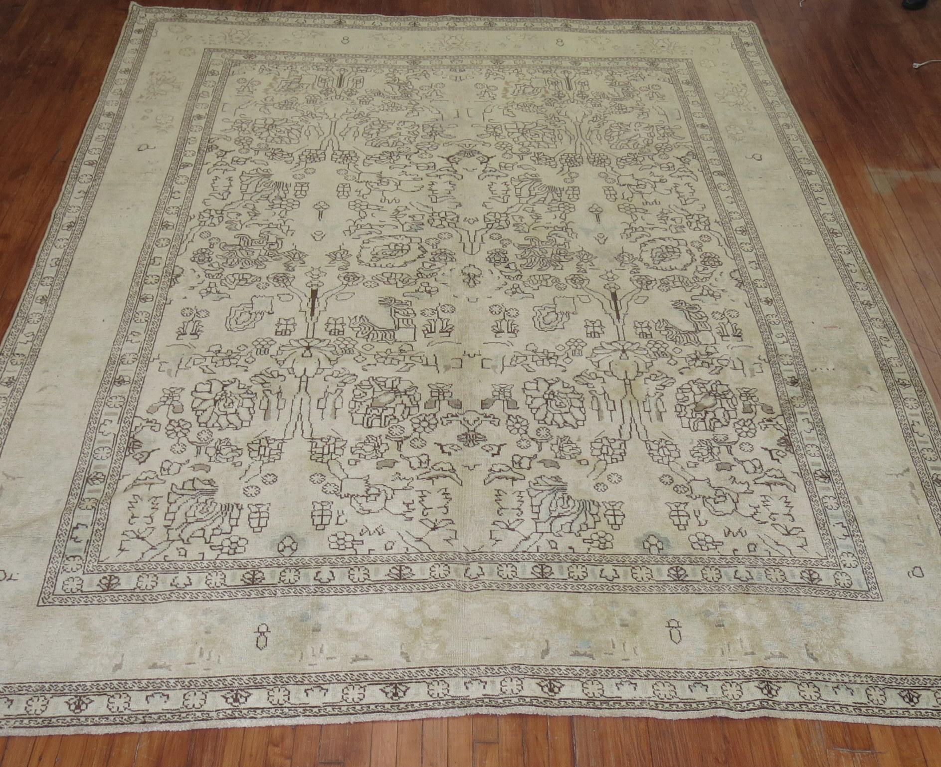 A mid 20th-century all-over floral pattern Persian Tabriz rug with brown and green accent colors on a creamy beige yellow field

Measures: 9'5'' x 12'6''.
