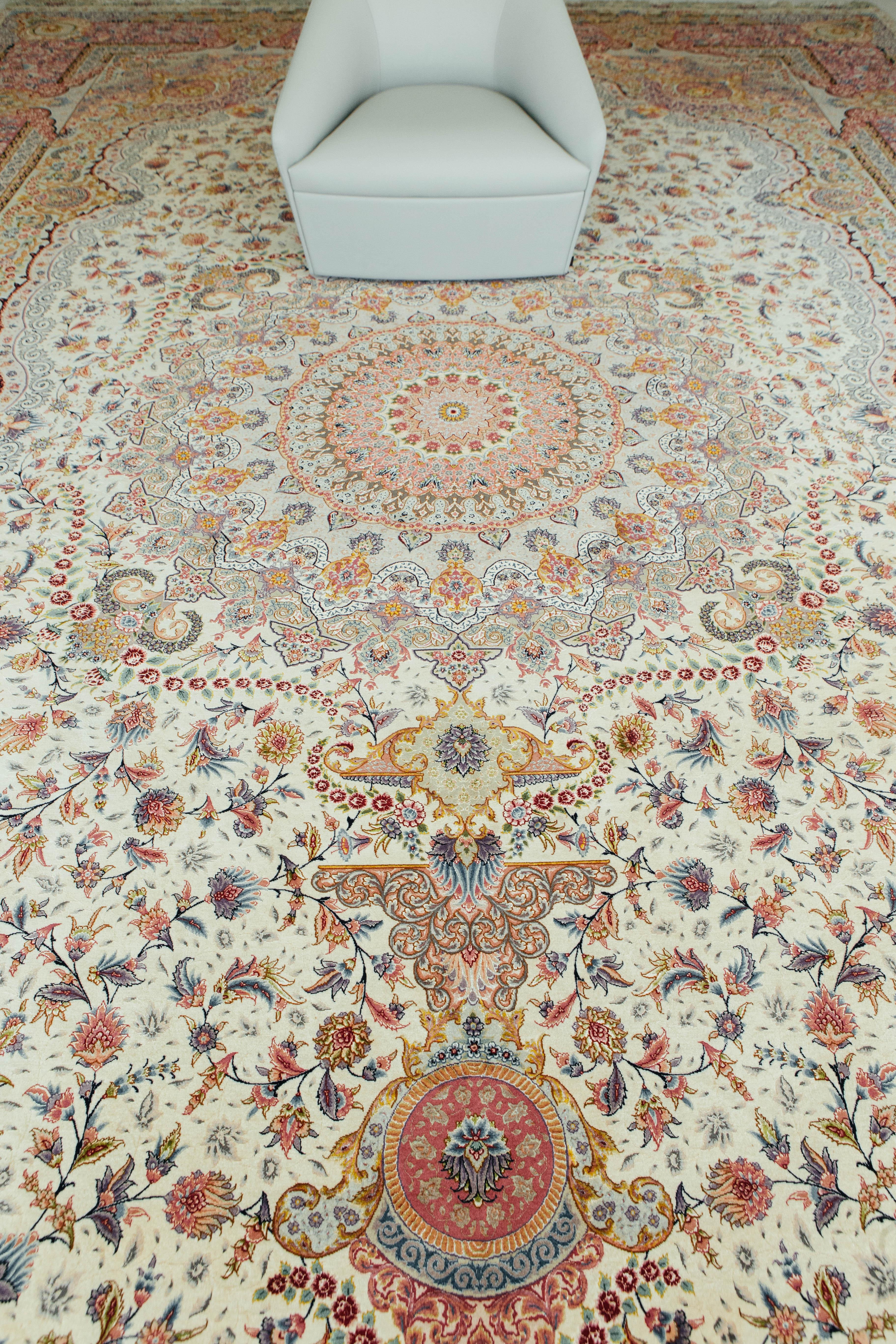 A gorgeous Persian Tabriz rug designed, woven, and signed by master weaver of Tabriz, Jalilnia. This fine wool and silk piece is nothing short of a masterful work of art. Weaved with fine knots are beautifully detailed floral scrolls and vibrant