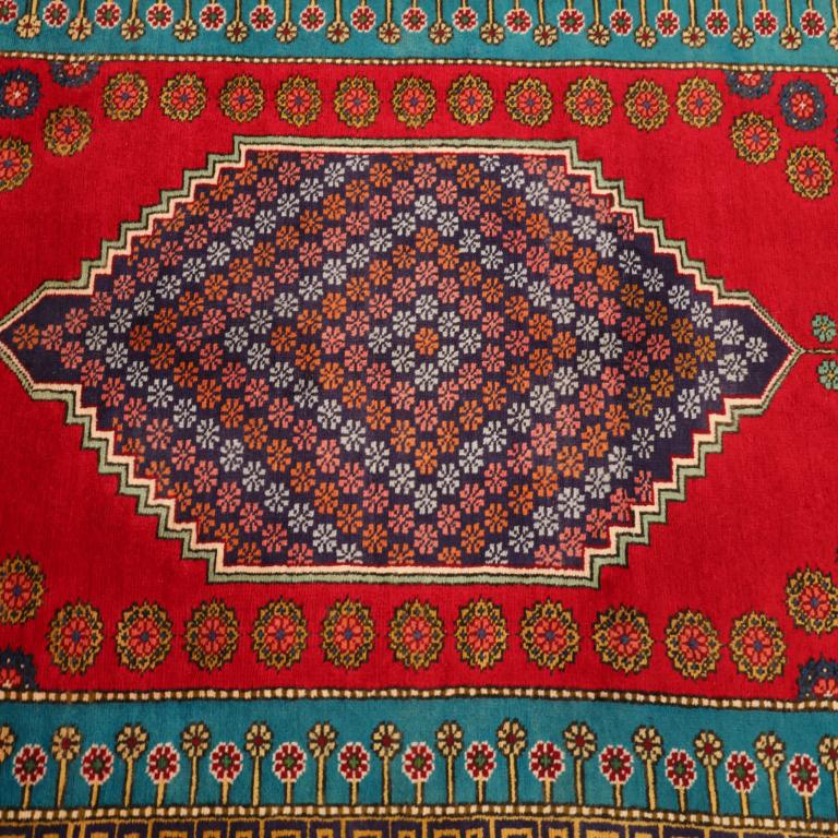 The Vibrant Legacy of a Traditional Iranian Tabriz Rug
A Jewel of Color and Enduring Heritage
Imagine a striking focal point unfurling in your home, a rug that pulses with the vibrant energy of ancient traditions and masterful artistry. This