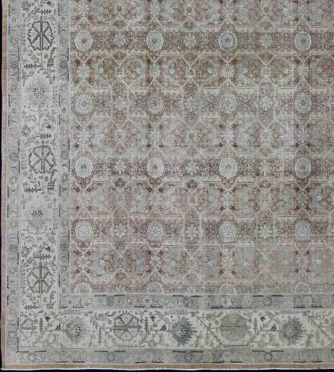 Antique Persian Tabriz rug with all-over floral design in ivory, blush, brown, light blue. Keivan Woven Arts / rug 1912-132, country of origin / type: Iran / Tabriz, circa 1920
Measures: 11'4 x 14'8.
This antique Persian Tabriz carpet features a
