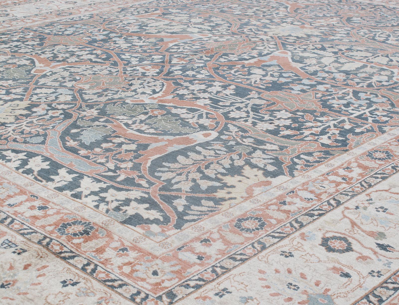 This Persian Tabriz hand-knotted rug is made from the finest hand-carded, hand-spun wool and distinguished by its excellent weave, and by the remarkable adherence to the classical traditions of Persian rug design. The city of Tabriz, in northwest