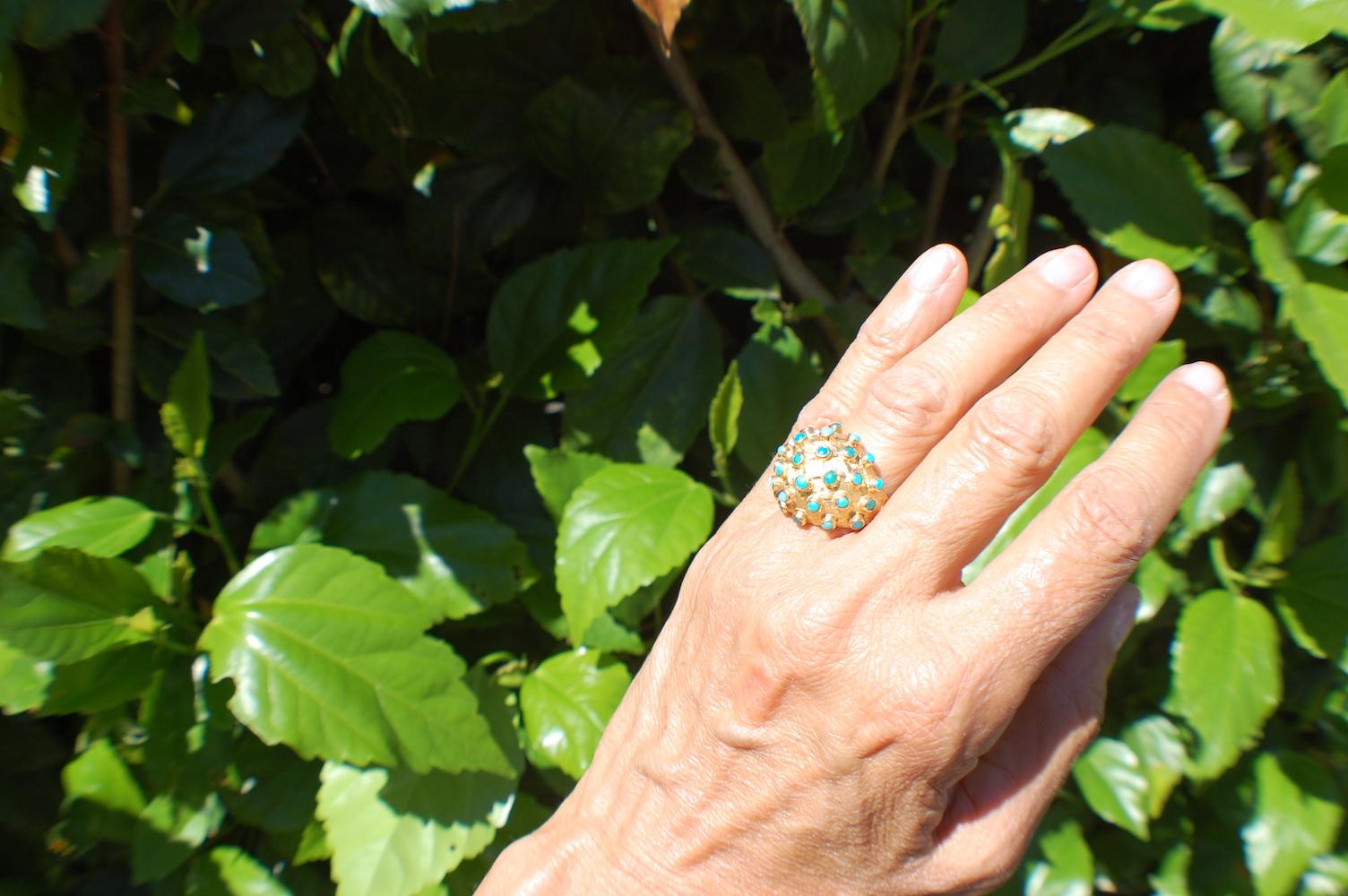 Persian Turquoise, Circa 1970's Dome Ring, 18 Karat Yellow Gold
Turquoise are individually set in bezels and raised from a dome measuring .75 