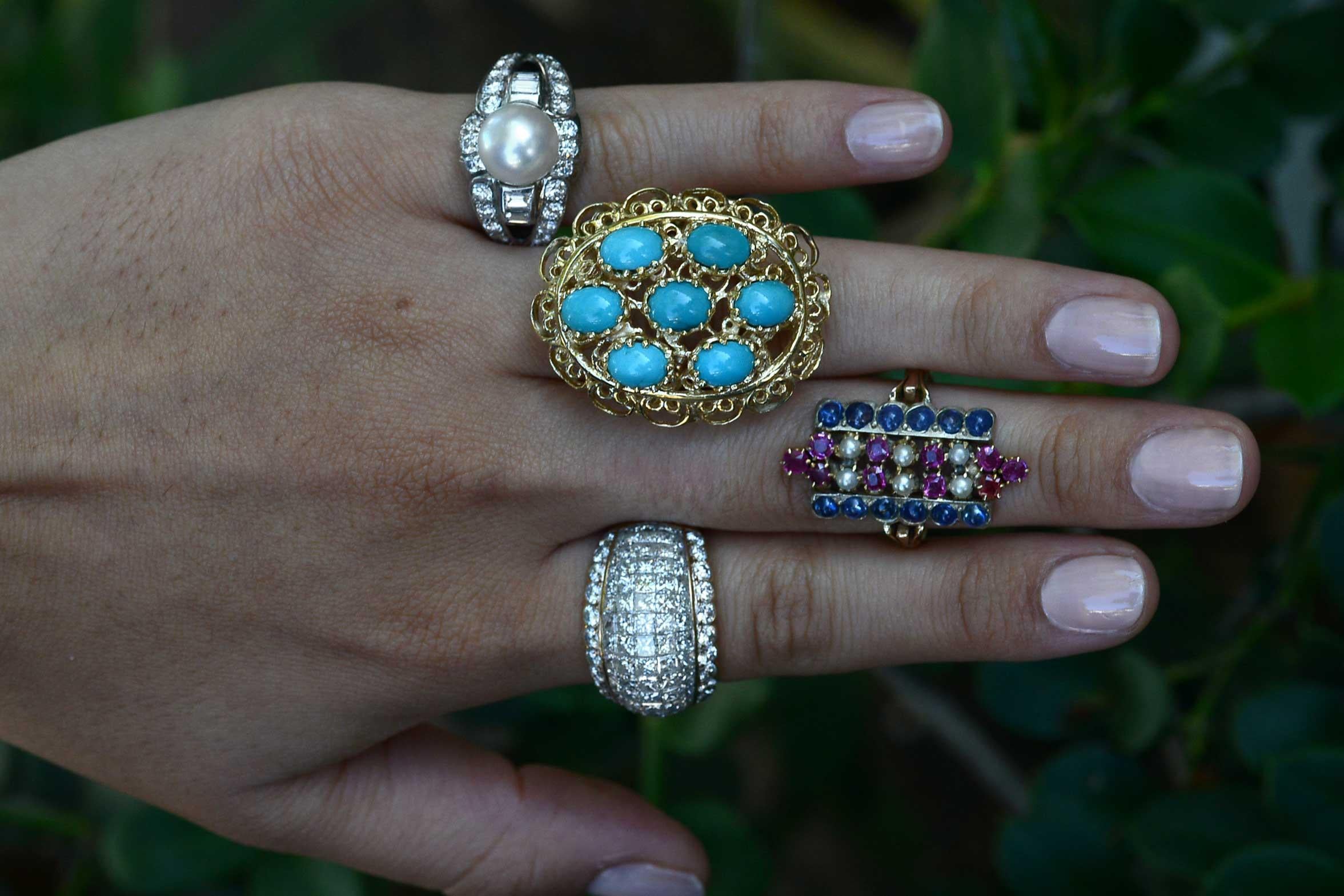 Looking like Elizabeth Taylor's rings in Cleopatra, this mid-century stunner commands attention. A cluster of 7 Persian turquoise cabochons arranged in an oval filigree-rich setting with HUGE finger coverage. A hefty chunk of gold, nearly a half