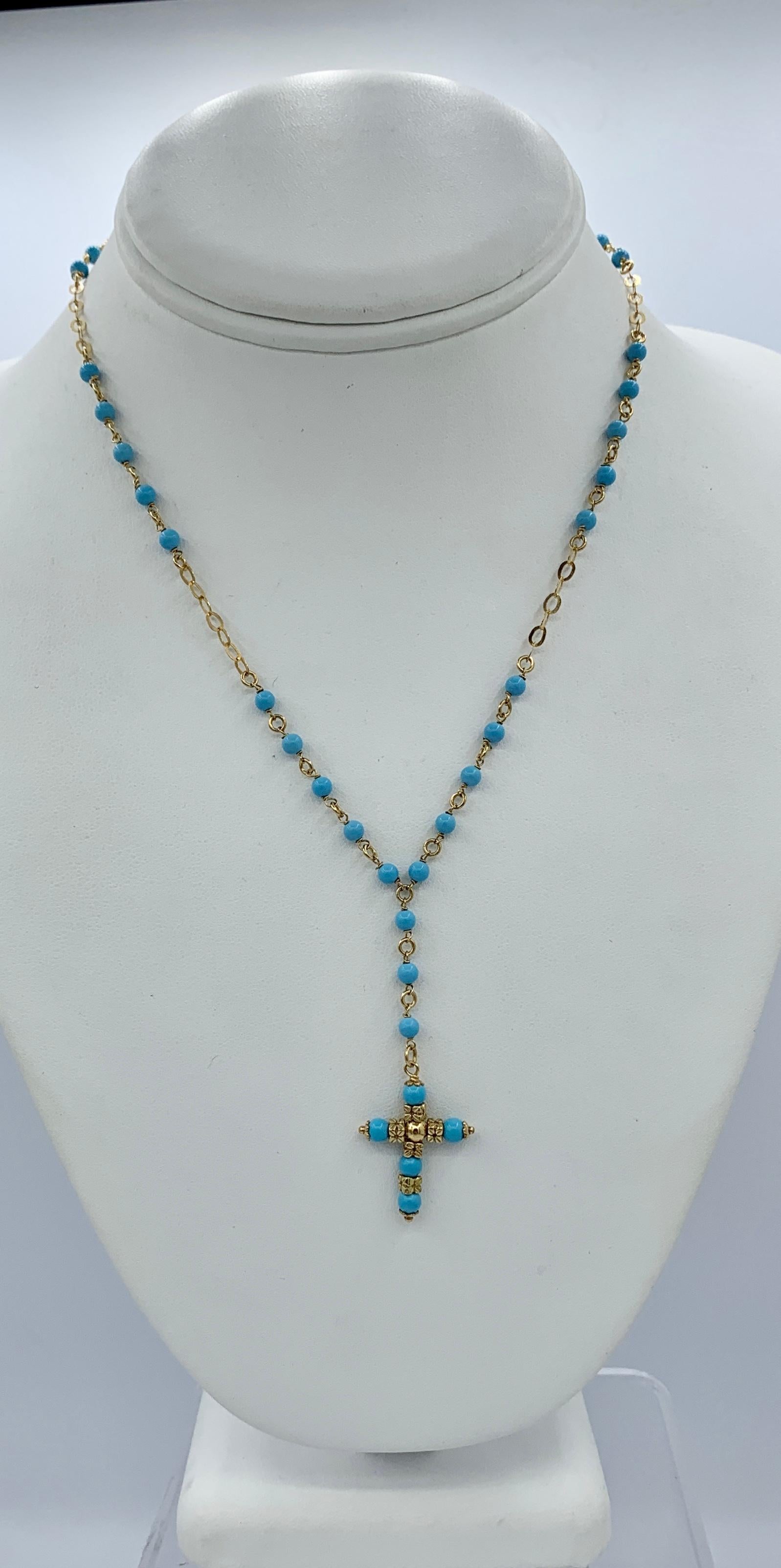 This is a beautiful Persian Turquoise 14 Karat Yellow Gold Cross Pendant Necklace.  The lovely necklace has Persian Turquoise beads interspaced with 14 Karat Yellow Gold links.  In the center is Cross pendant with Persian Turquoise and flower motif