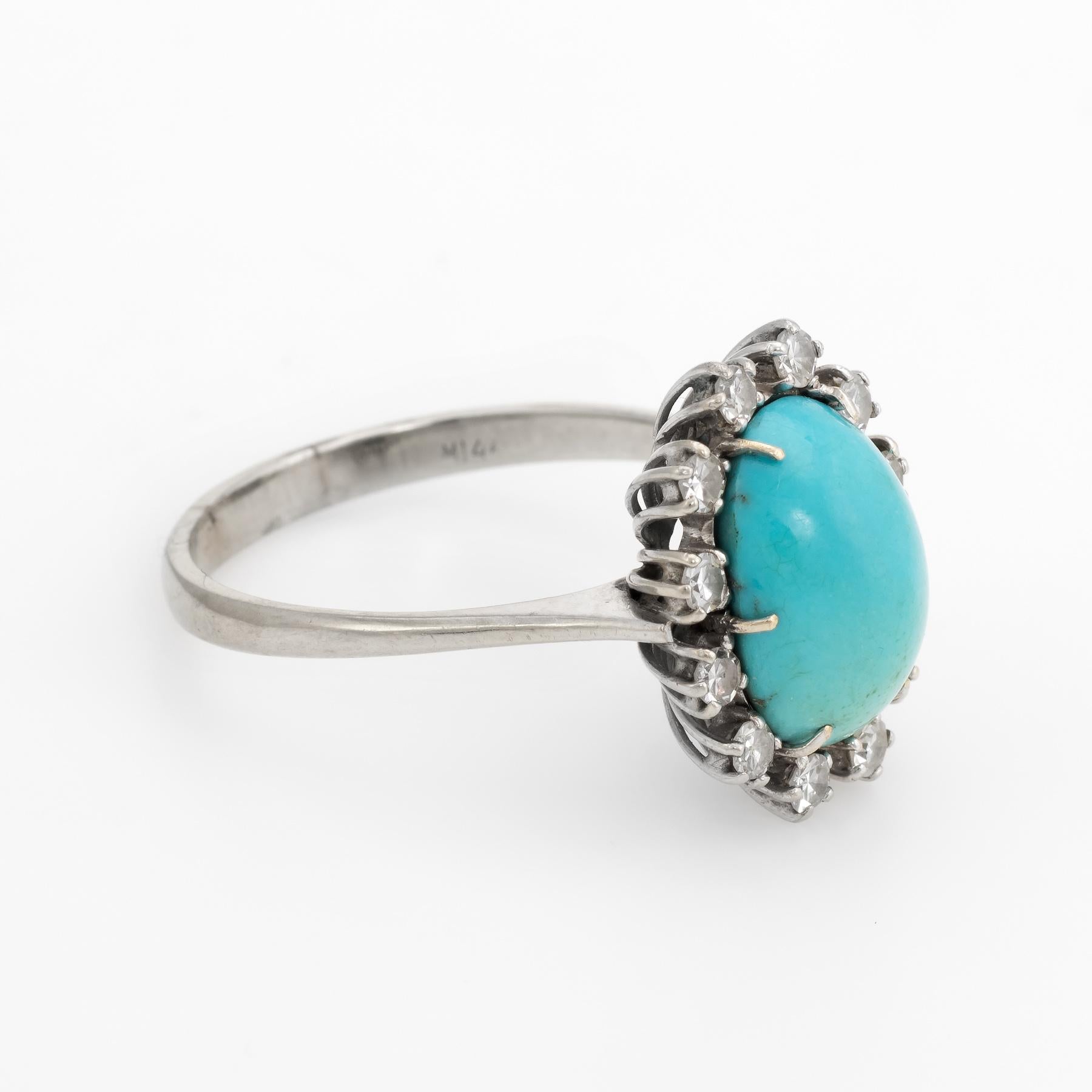 Elegant vintage cocktail ring (circa 1950s to 1960s), crafted in 18 karat white gold. 

Centrally mounted cabochon cut Persian turquoise measures 12mm x 9mm (estimated at 4 carats) is accented with 11 approx. 0.03 carat single cut diamonds (0.33