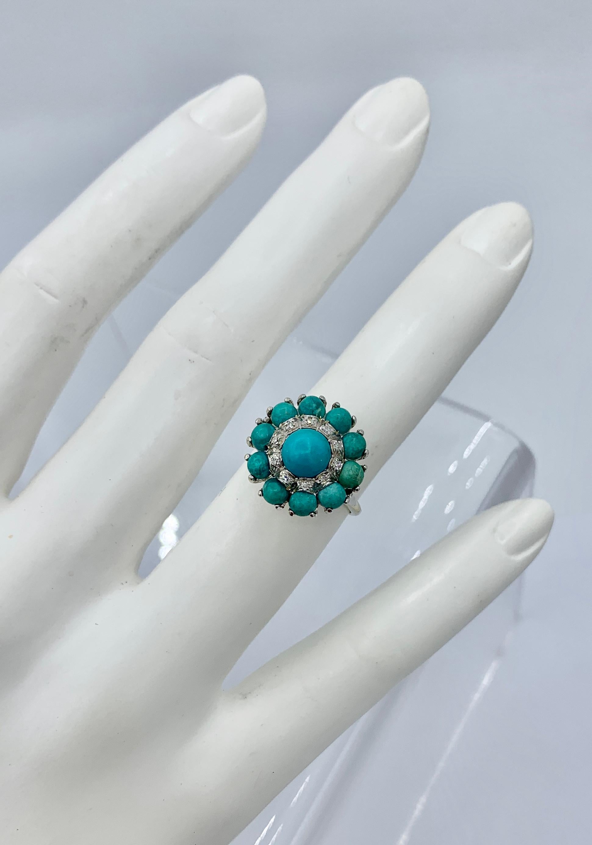 This is a gorgeous Antique Retro - Art Deco Ring with gorgeous natural Persian Turquoise cabochons of stunning beauty with a halo of 10 sparkling white Diamonds set in 18 Karat White Gold.   The central Persian Turquoise is a beautiful large domed