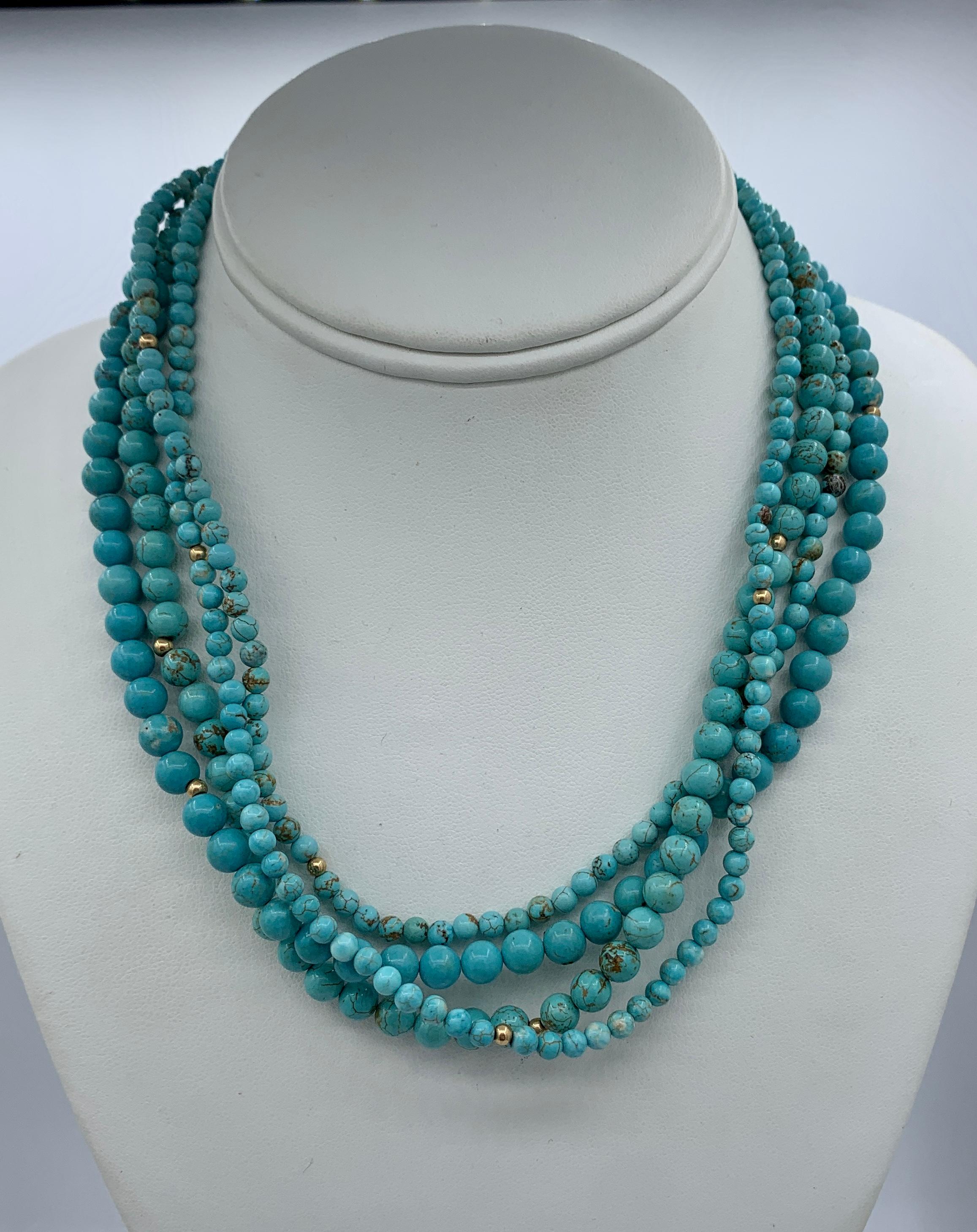 This is a beautiful Persian Turquoise 14 Karat Yellow Gold four strand Torsade Necklace.  The lovely necklace has four strands of natural Persian Turquoise beads interspaced with 14 Karat Yellow Gold beads with 14 Karat Gold clasp.  The elegant