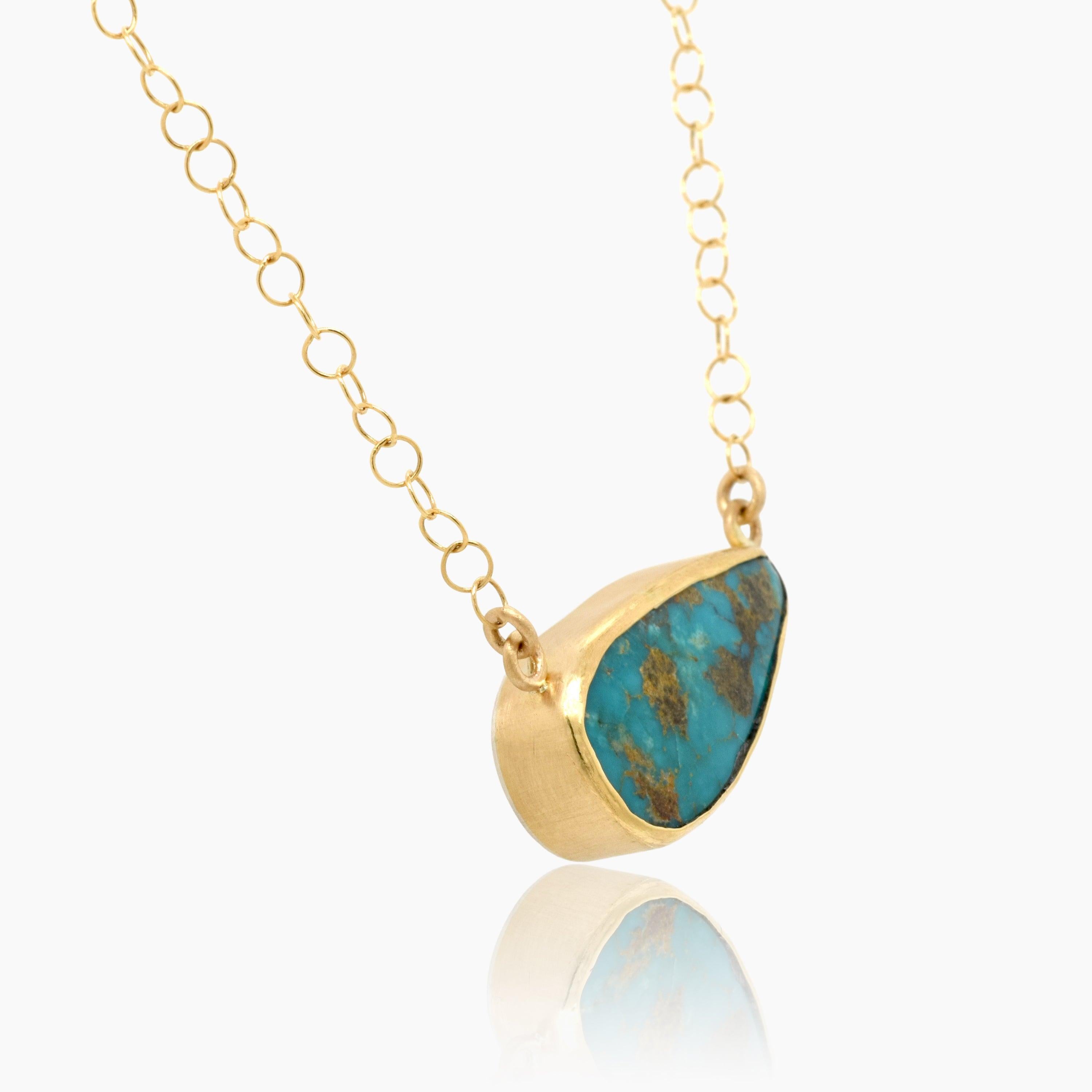 Ocean blues and greens make this 13 carat teardrop shaped Persian Turquoise special.  Encased in 18K gold with an 18K gold link chain, it is backed with a textured sterling silver as well as a a textured brushed finish on the sides.    The necklace