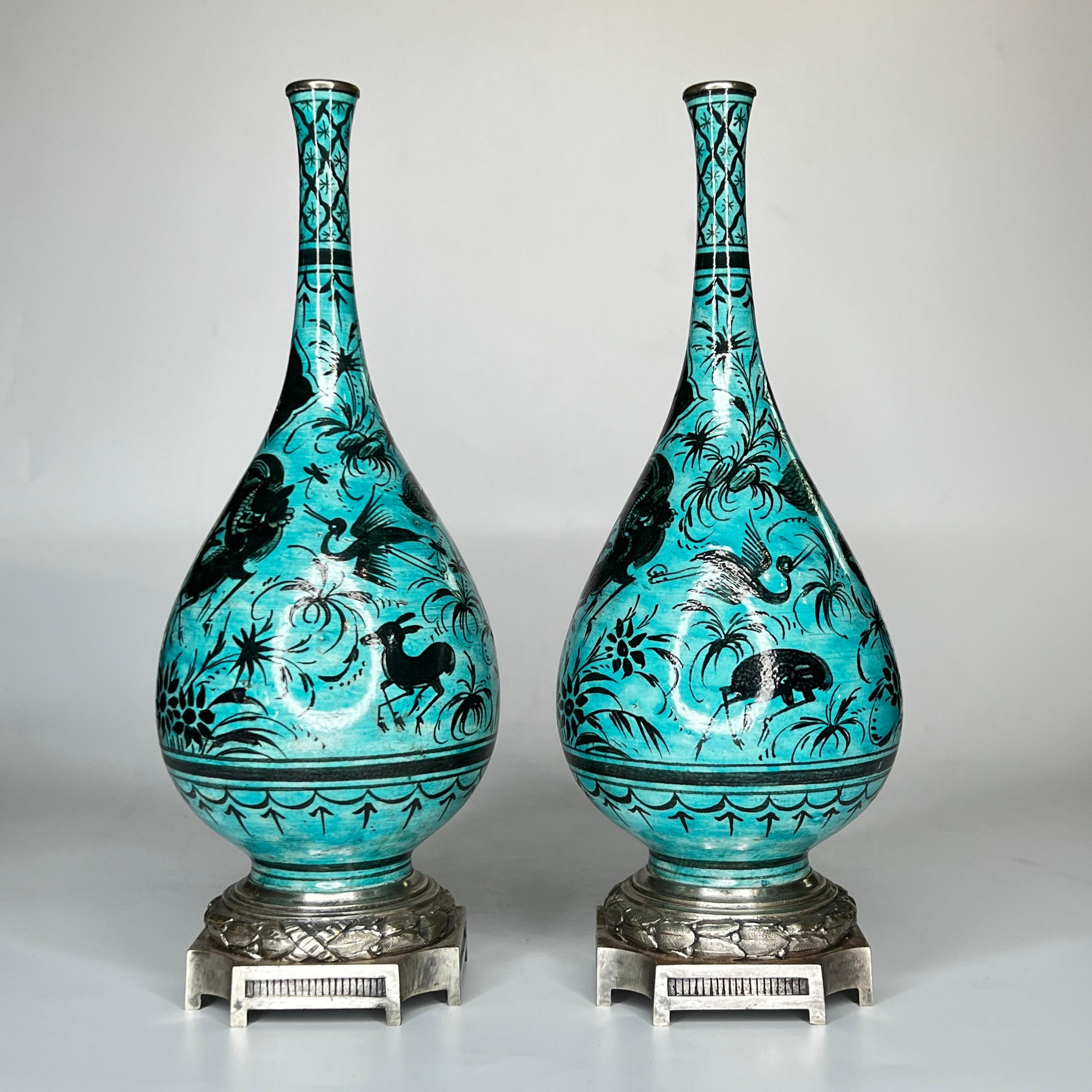 Our pair of Persian ware ceramic bottle vases in the 17th century Iznik style, attributed to Samson et Cie, circa 1870-1890, are decorated with the figures of lions or panthers attacking deer, with cranes and foliage on a turquoise ground. Mounted