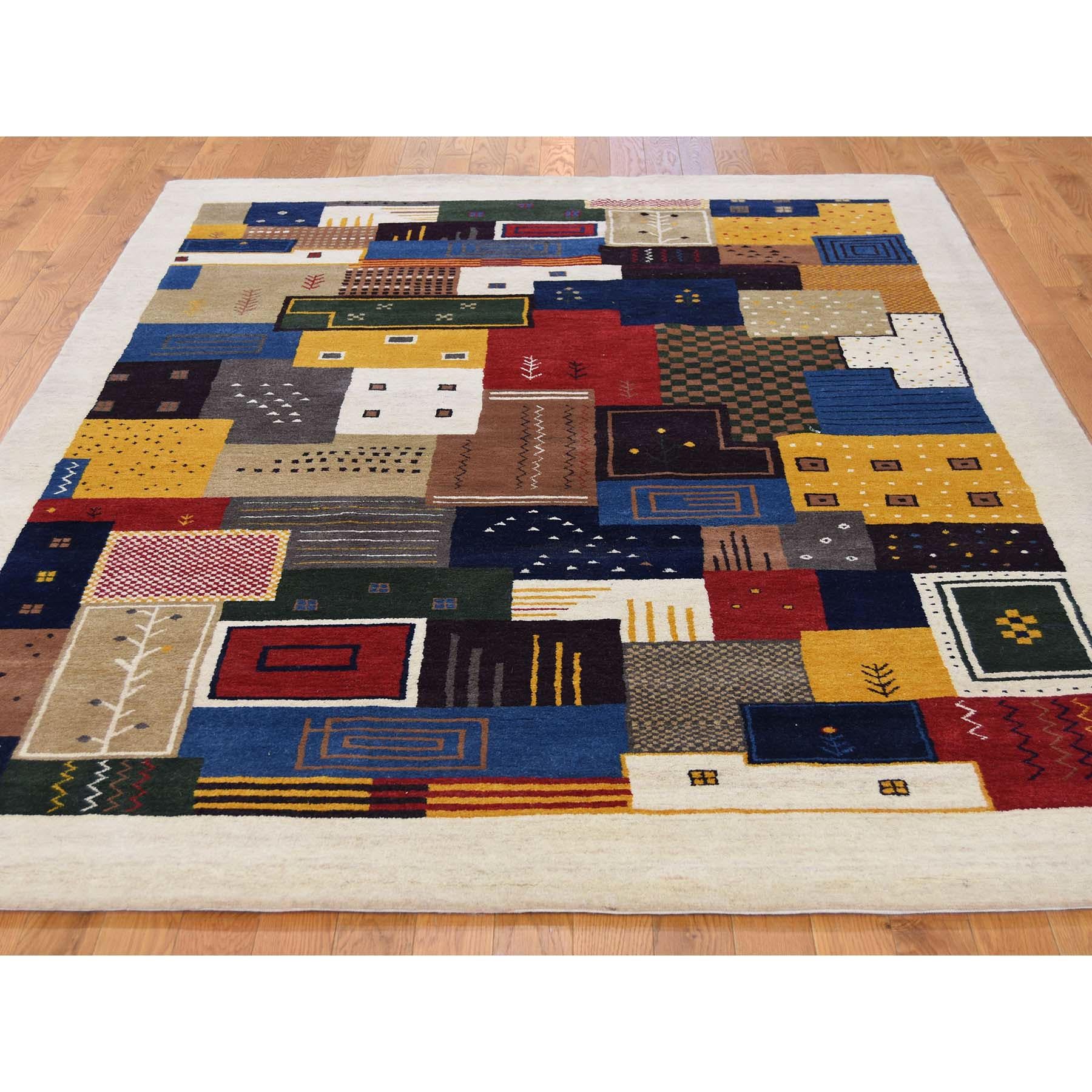 This is a truly genuine one-of-a-kind Persian wool handmade Lori Buft Gabbeh patchwork design rug. It has been knotted for months and months in the centuries-old Persian weaving craftsmanship techniques by expert artisans. Measures: 5'9