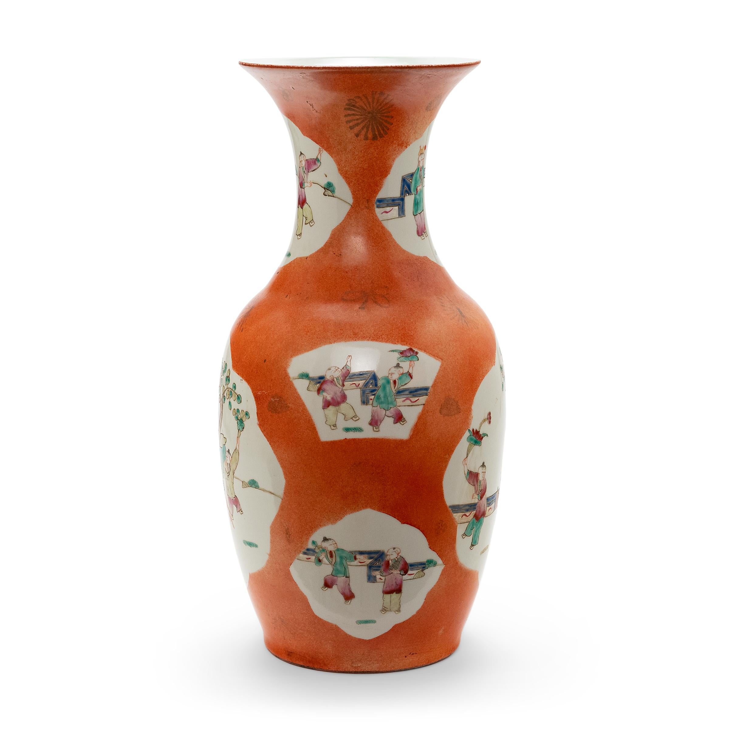 This phoenix tail vase is the perfect example of enduring Chinese symbolism and design. The body and flared neck of the vase bears a cartouche painting containing a picturesque scene. Each vignette displays a group of young boys in a traditional