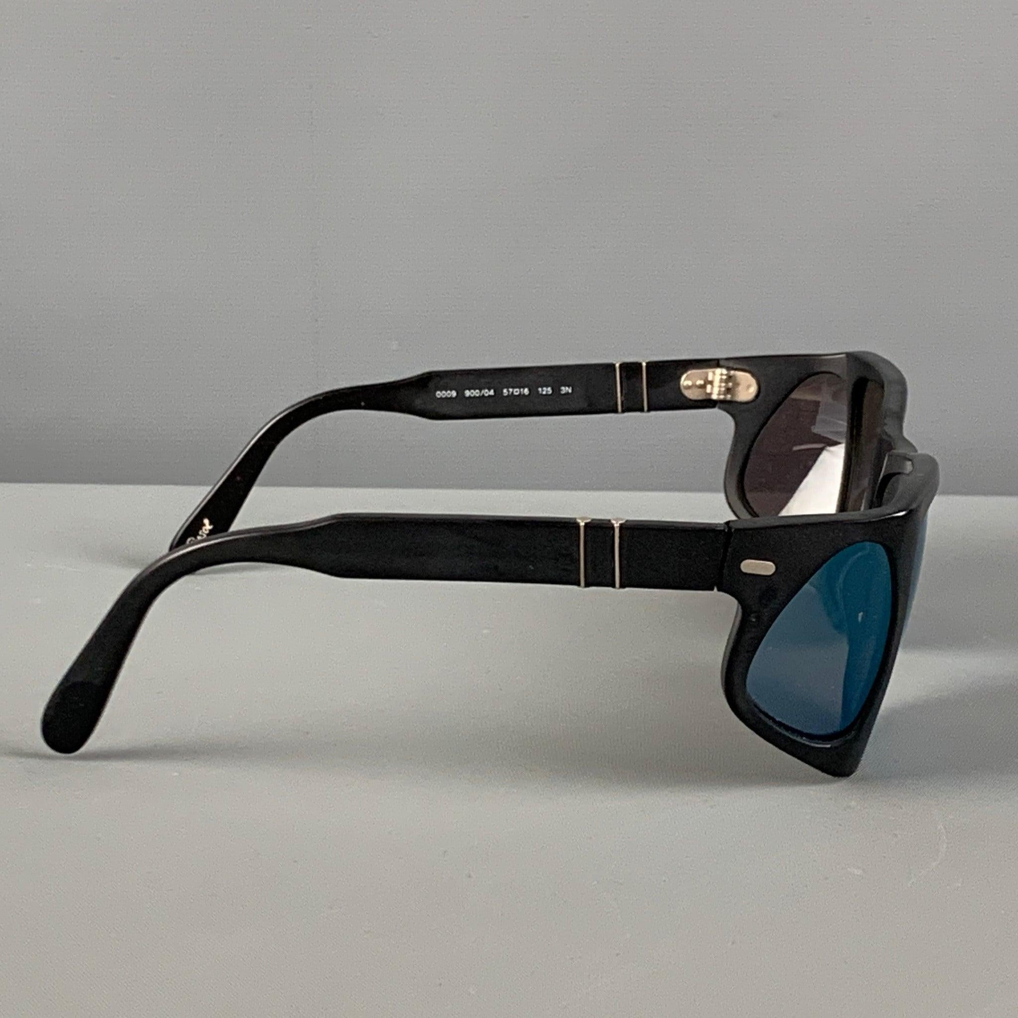PERSOL sunglasses comes in a black acetate featuring a shield design, silver tone hardware, and blue tinted lenses. Made in Italy.
Very Good
Pre-Owned Condition. 

Marked:   0009 900/04 57-16 125 3N 

Measurements: 
  Length: 11.5 cm. Height: 5 cm.
