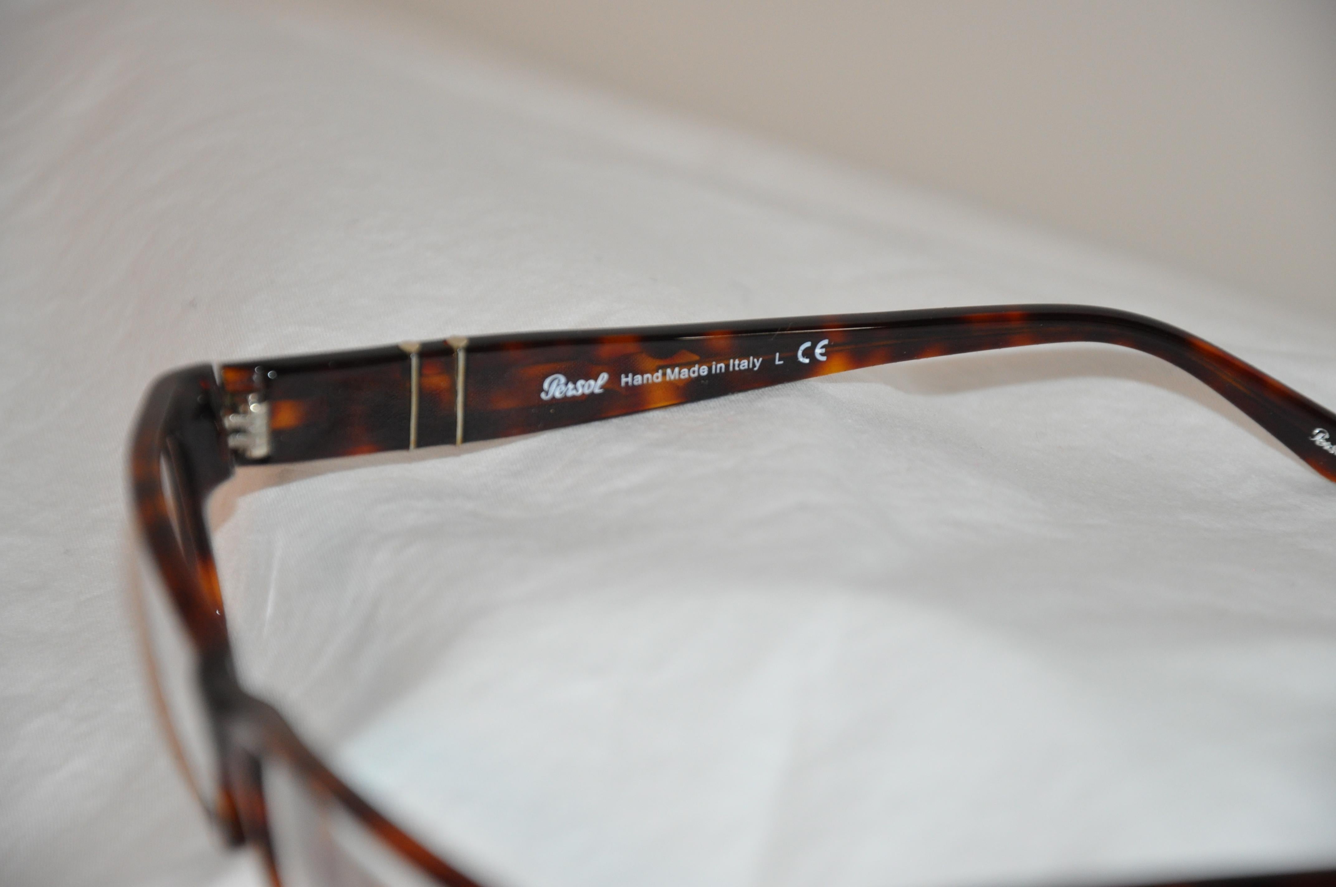 Persol's wonderfully detailed thick tortoise shell lucid glasses are superbly accented with silver hardware along both corners as well as along both arms. Hand-made in Italy, the front measures 5 1/4 inches across the front, the height is 1 1/4
