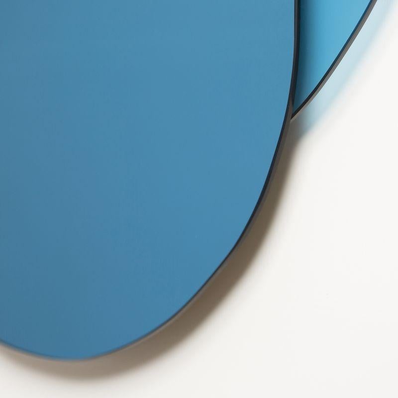 This wall mirror juxtaposes coloured matte and coloured reflective glass in stylized lines of male and female faces to leave a sign of a presence on the wall or lend the “personal reflection” to anyone who stops in front of them.
