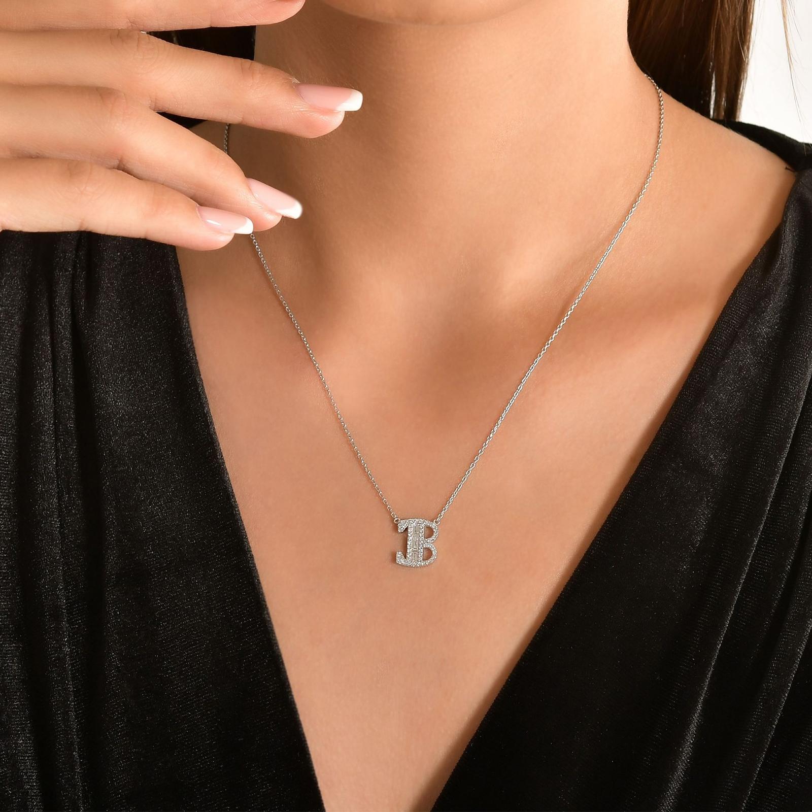 This Beautiful Baguette Diamond Letter Pendant Is Entirely Handcrafted In 14 Karat White Gold. 
The Letter B Pendant Is Garlanded With Channel-Set Baguette-Cut Diamonds And Prong Set Brilliant Round Diamonds Weighing .37 Carats. All Of The Stones