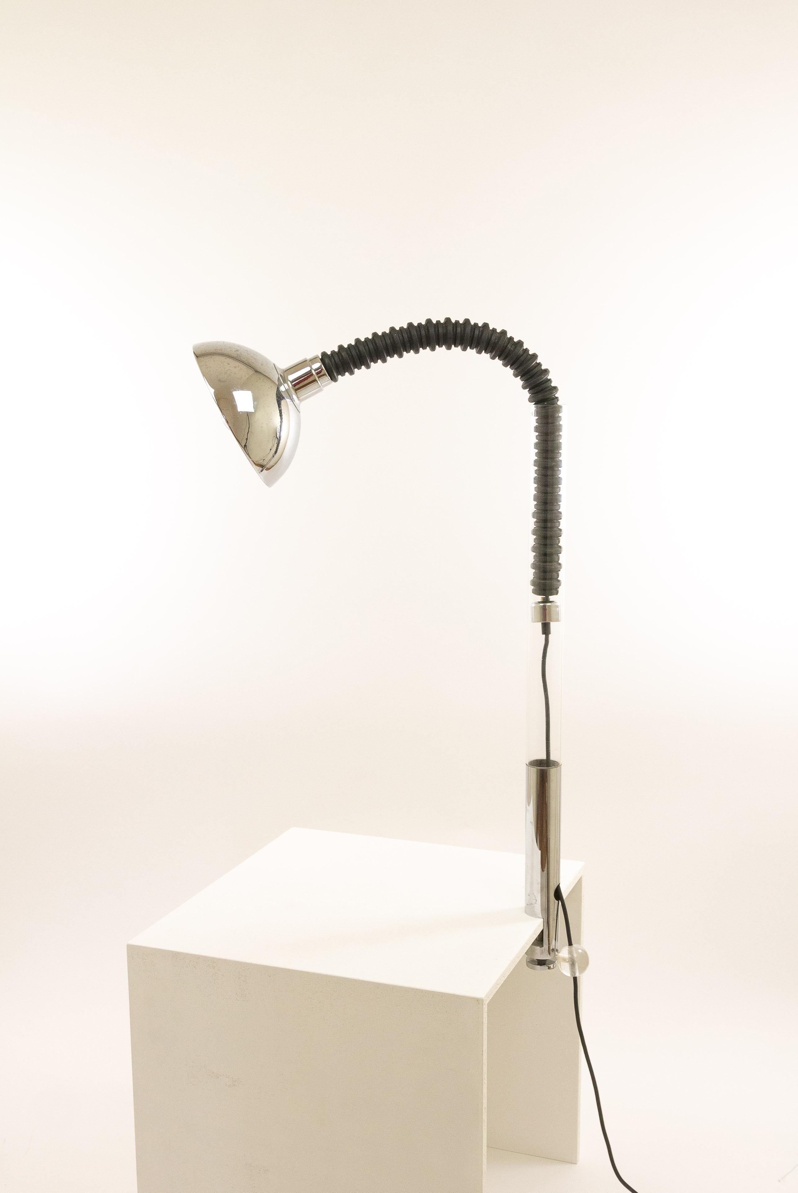 Chrome and plexiglass clamp table lamp with flexible arm designed and produced by Cosack Leuchten in the 1970s.

The flexible, partly rubber arm can be pulled out. In this way the reflector can be placed in different positions, so that the lamp can