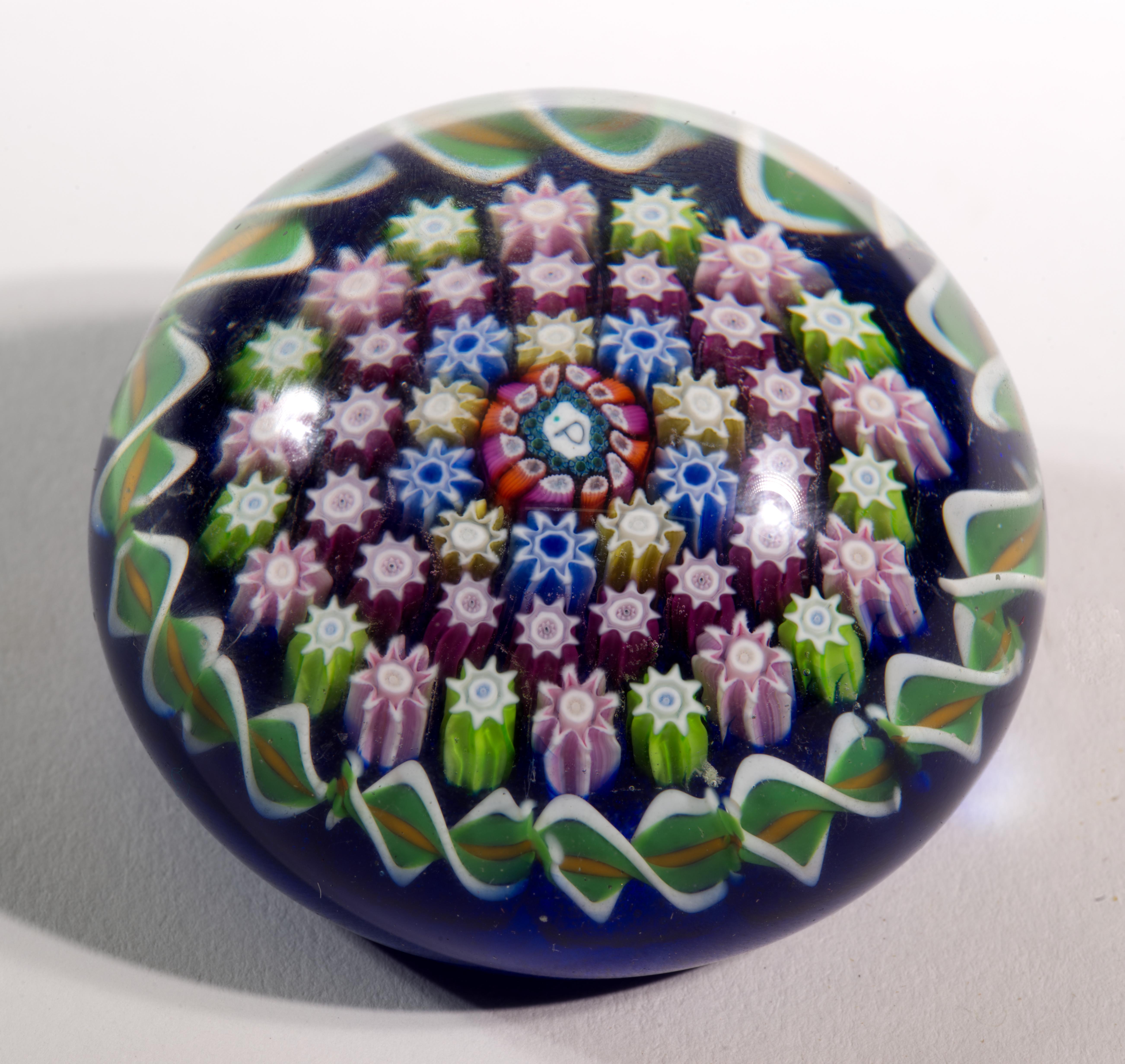  Vintage Perthshire paperweight features large central P cane (signature cane), surrounded by 3 rings of highly detailed millefiori canes in green, pink, yellow, and blue colors, and a ring of twists in green, yellow, and white colors, placed on