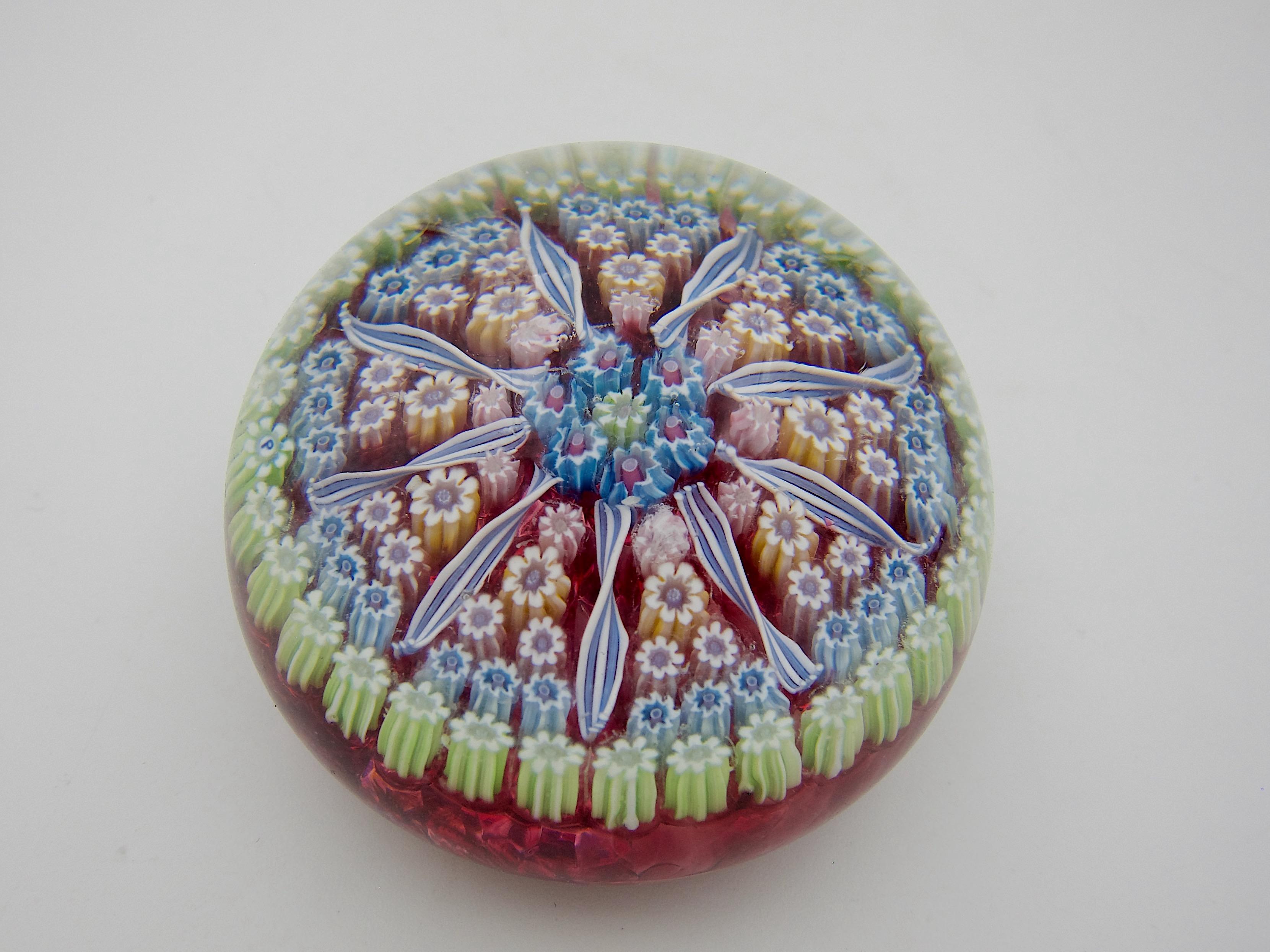 A vintage millefiori art glass paperweight, handcrafted by Perthshire Paperweights, Ltd. of Crieff, Scotland and dating to the last quarter of the 20th century. The domed weight was designed in a 1-1-2-3 pattern of millefiori canes separated by 9