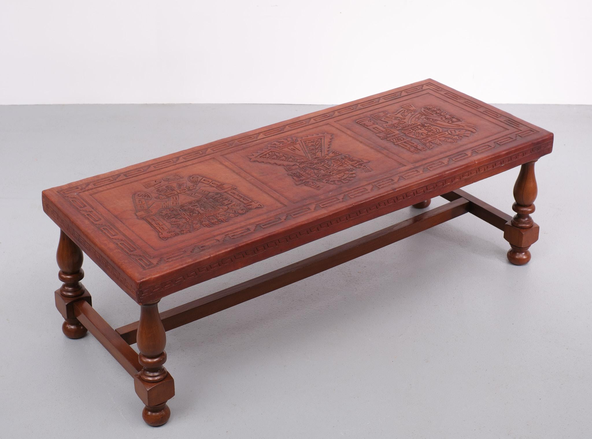 Three pre-Inca figures grace this coffee table, handcrafted by Abel Rios. Inspired by the rich cultural heritage of his native Peru, Rios skillfully embosses leather using traditional tools and exceptional creativity. This elegant mohena wood table